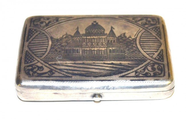 Russian Silver Cigarette Box: Having a scene of a Russian villa on front with a geometric design on back. Measurements: