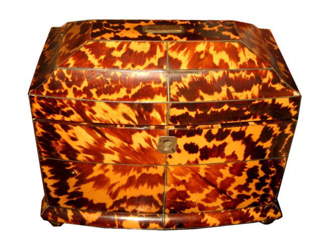 Antique Tortoise Shell Tea Caddy: Having a fitted interior with tortoise shell lids with ivory pulls in a silver mounted tortoise vox raised on bronze bun feet. (One of four missing.) Measurements: 7.25" l x 4.25", 6.25" h x 4.6" w