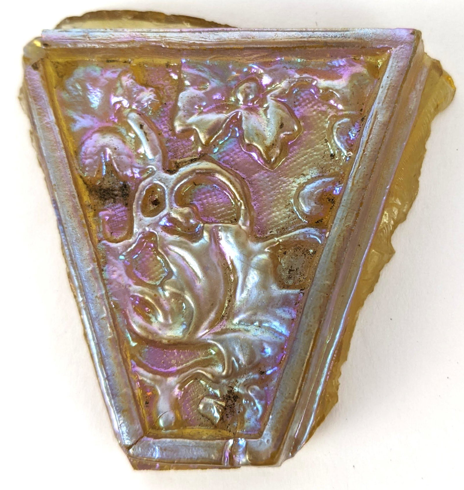 Tiffany-Style Tile: Tiffany-style triangular floral design tile. From the Estate of June Hirsch Jones. [2" H x 2" W x 1/2" D]. In good condition.
