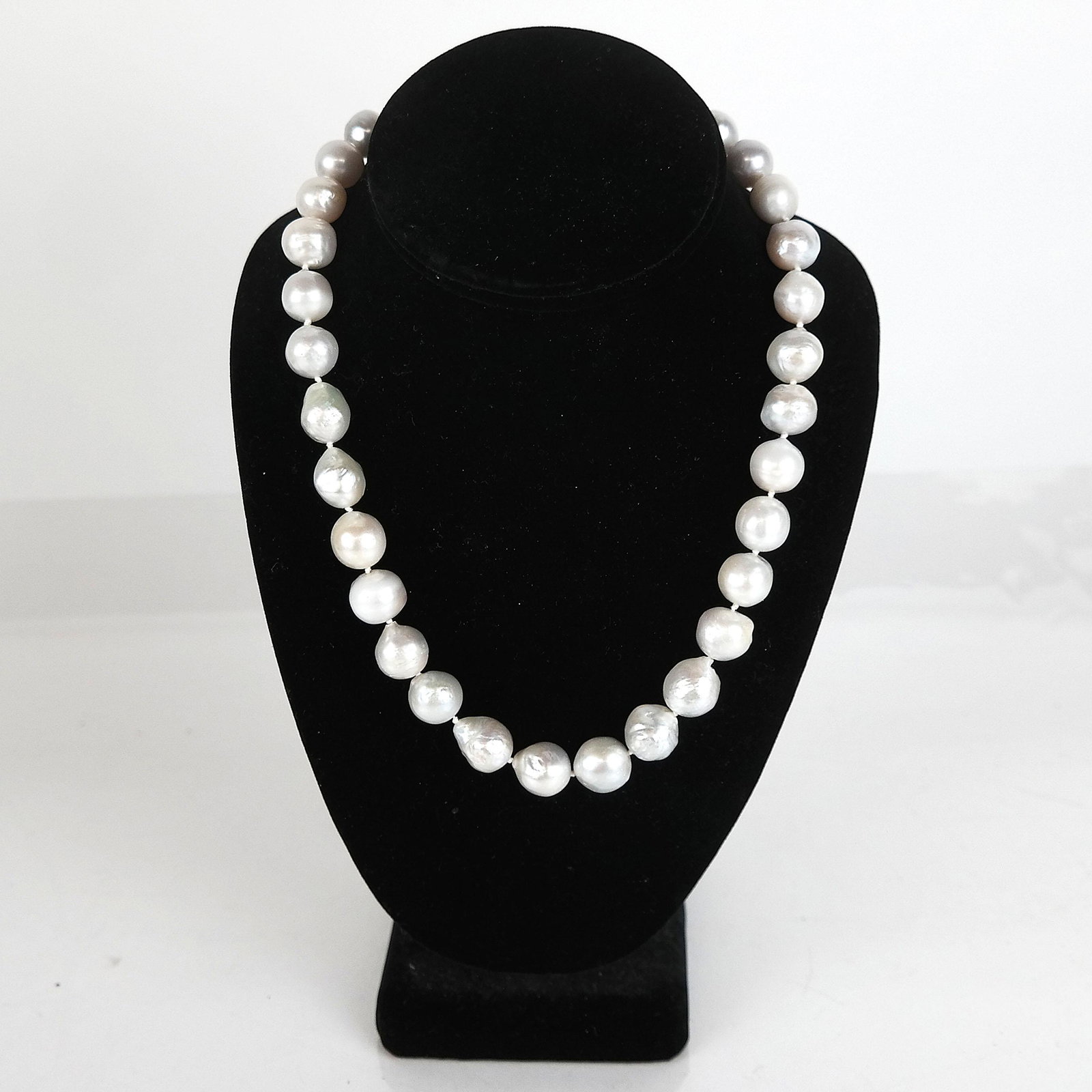 Freshwater Baroque Pearl & 14K Necklace: Freshwater baroque pearl necklace, having a round 14K yellow gold bezel clasp. Retailed by Yokoo, Japan. Approx. 18” L. In good condition.