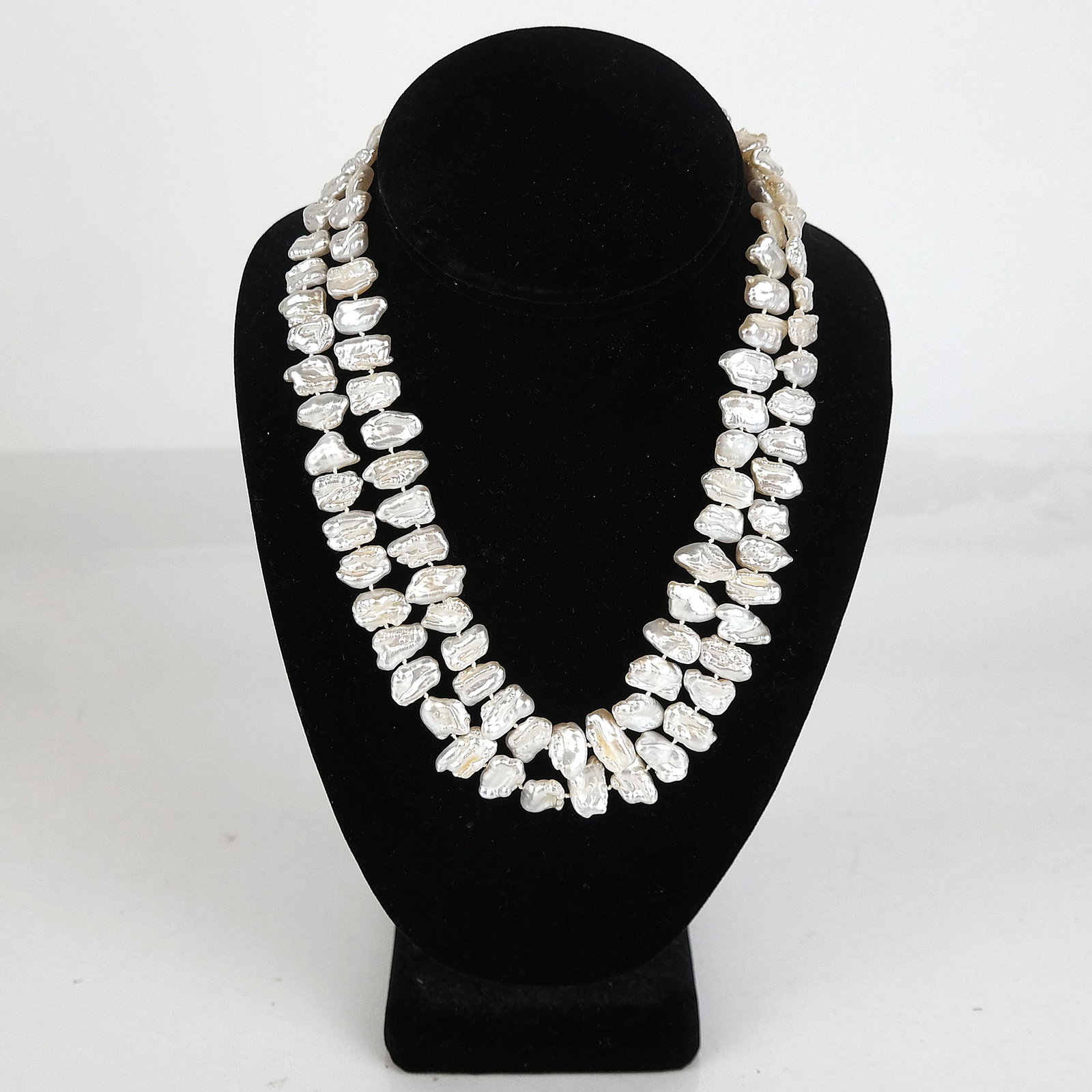 Baroque Freshwater Pearl Necklace: Baroque freshwater pearl necklace, having a lavender jade and 14K yellow gold clasp. 35" L. In good condition.
