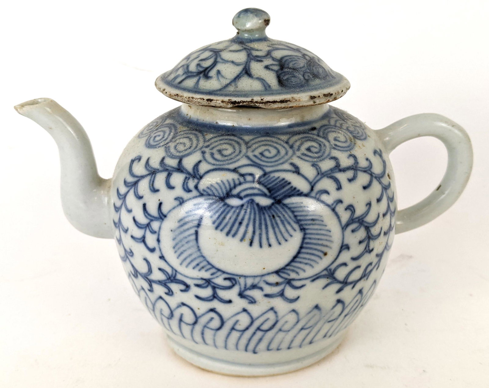 Blue & White Chinese Export Teapot: Blue and white Chinese Export teapot. From the Estate of June Hirsch Jones. [5" H x 6" W x 3 1/2" D]. Chips on spout and lid.