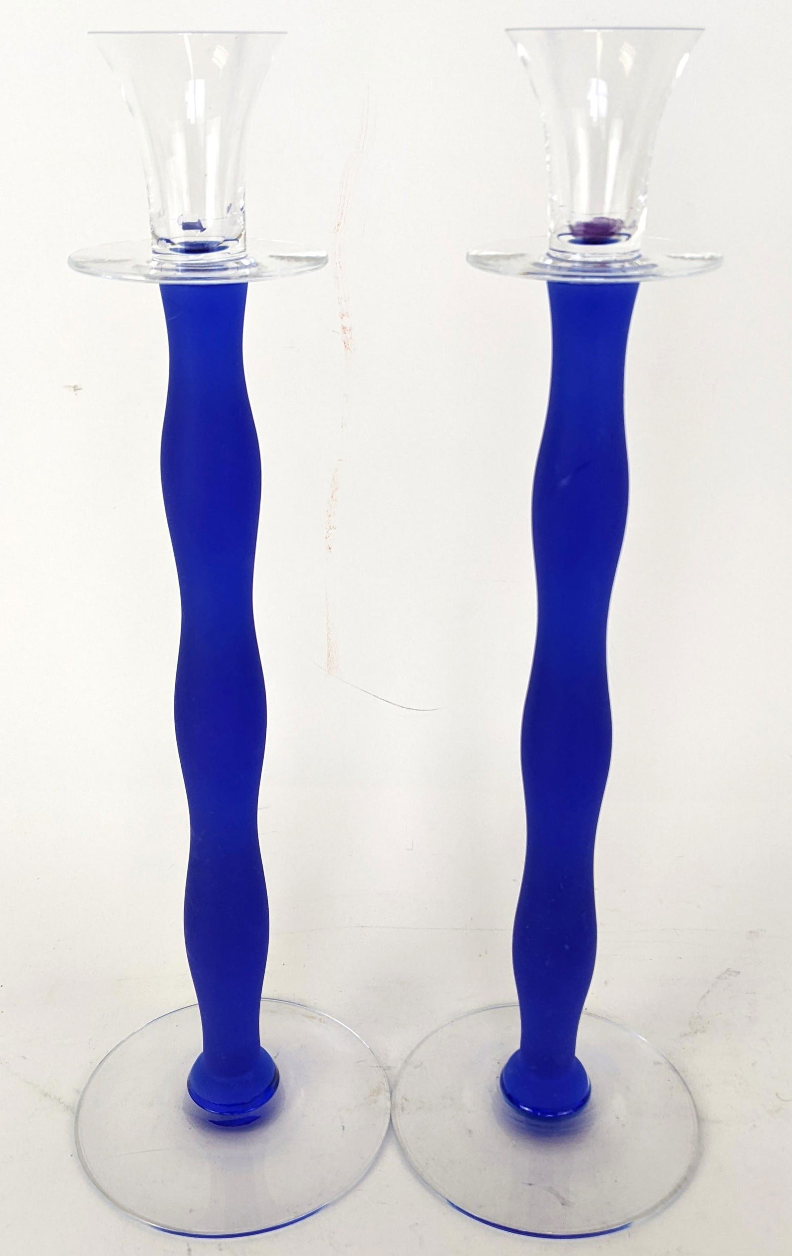 Two Glass Orrefors Candlesticks: Two "Celeste" by Anne Nilsson for Orrefors glass candlesticks in blue and silver art glass, designed with undulating-shaped columns. From the Estate of June Hirsch Jones. [14 3/4" H x 4 1/2" Diam. (ba