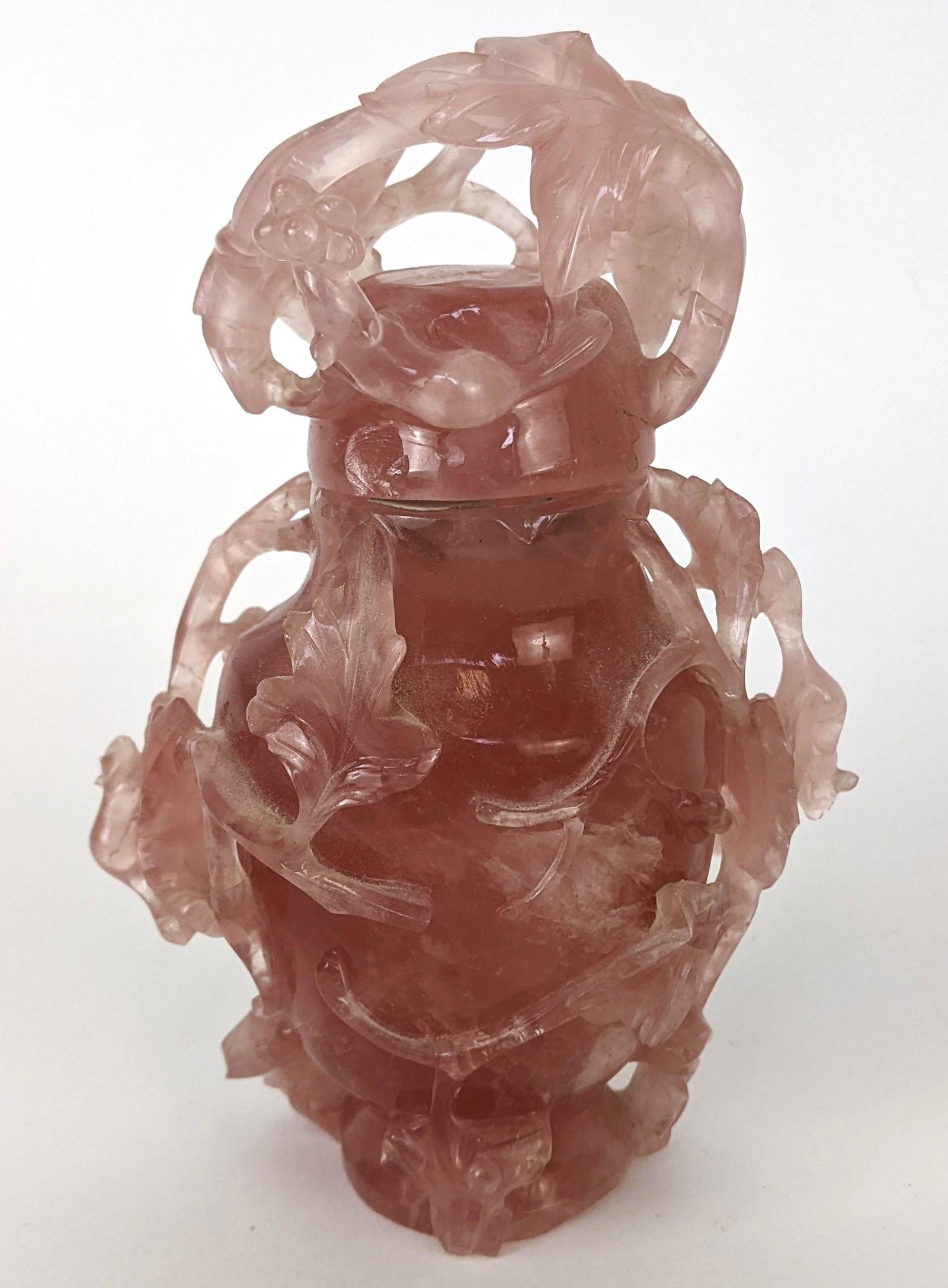 Chinese Rose Quartz Lidded Jar: Chinese rose quartz lidded jar, decorated with foliage and running squirrels. From the Estate of June Hirsch Jones. [6 1/4" H x 4" W x 2 1/2" D[]. Chips.