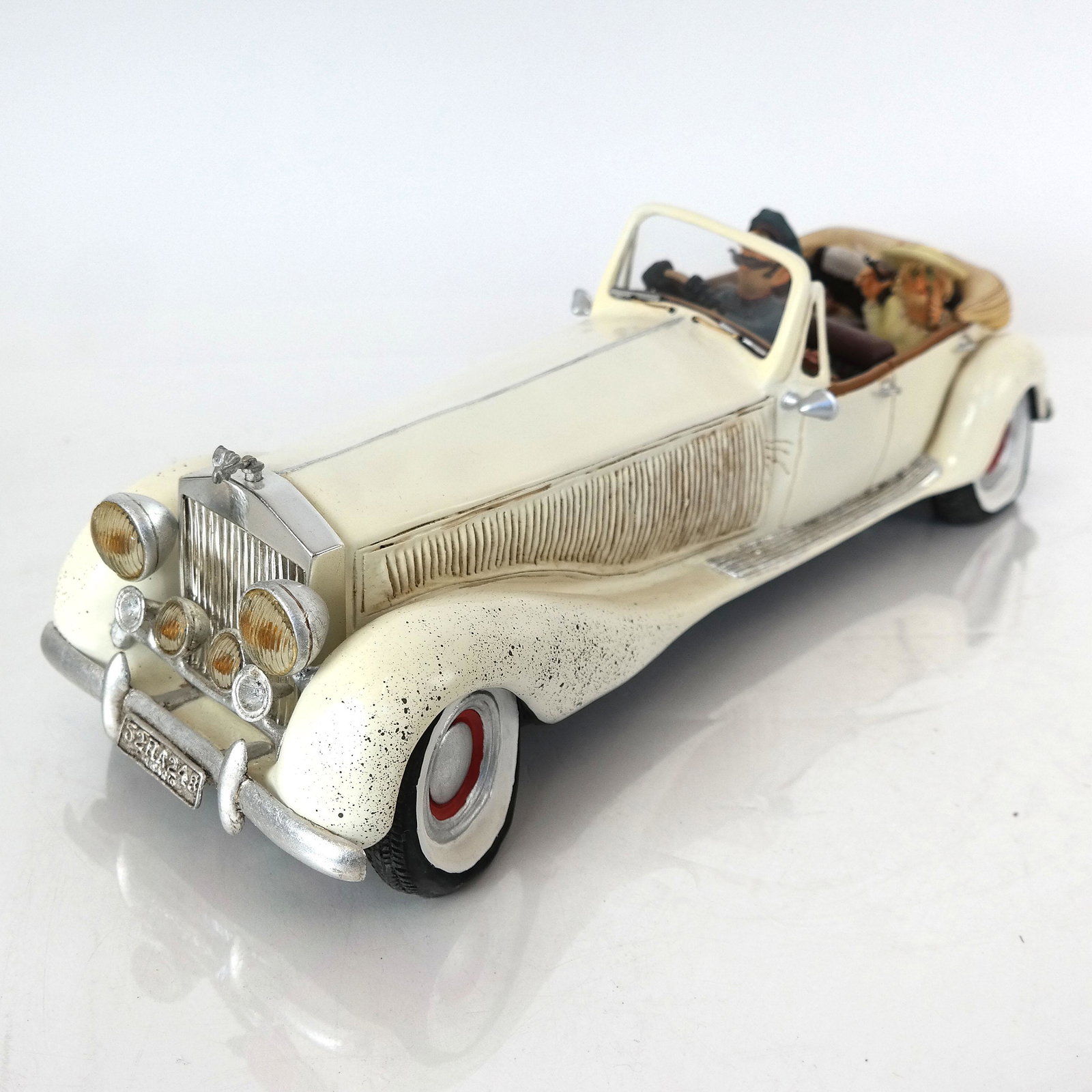 French Forchino Car Sculpture: French Forchino painted resin car sculpture including a driver and elderly woman passenger. From the Estate of June Hirsch Jones. [5" H x 15" W x 6" D]. In good condition.