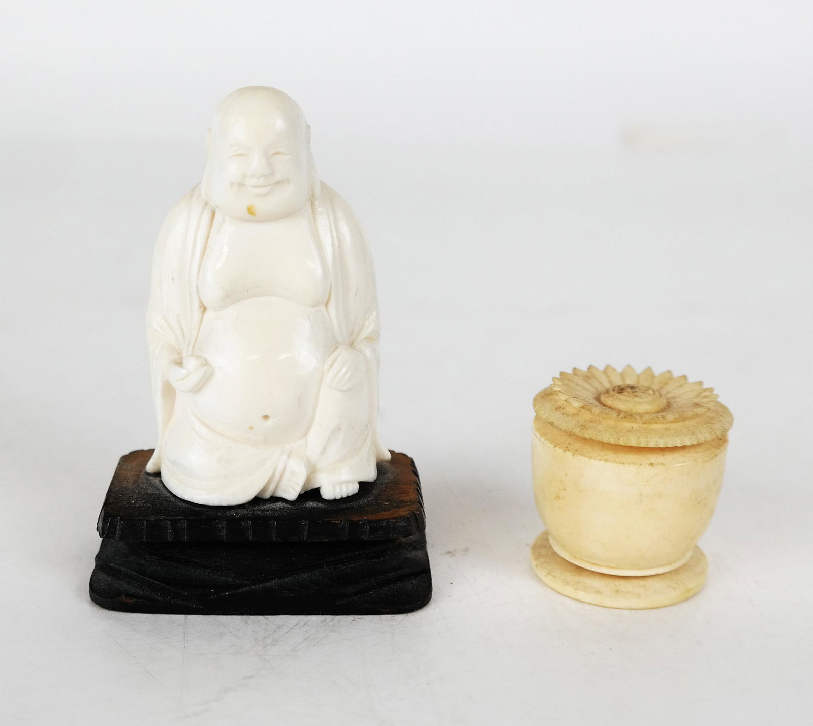 Two Chinese Carved Bone Objects: A Buddha and a small bowl with applied flower lid. Provenance: Estate of Florence & Herbert Irving. [Buddha: 3 1/4" H (including base)]. In good condition.