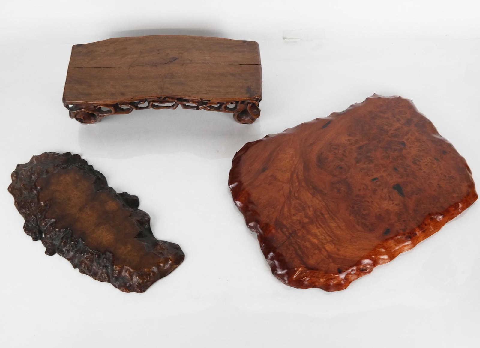 Three Polished Teakwood Stands: Three polished teakwood slices, for use as stands or bases. Provenance: Estate of Florence & Herbert Irving. [Largest: 14" H x 10" W]. In good condition.