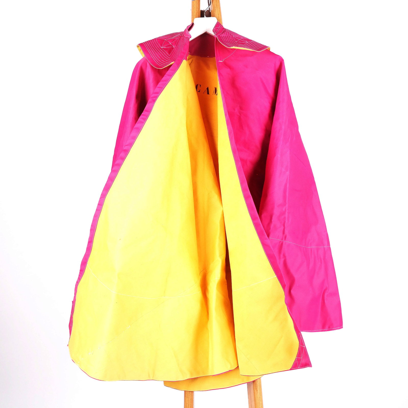Signed Matador Cape - Paco Camino: Signed Paco Camino matador cape, in pink with yellow lining. One size. Inscribed in marker, "To Henry B. Walter". [45 1/2" Long]. In good condition.