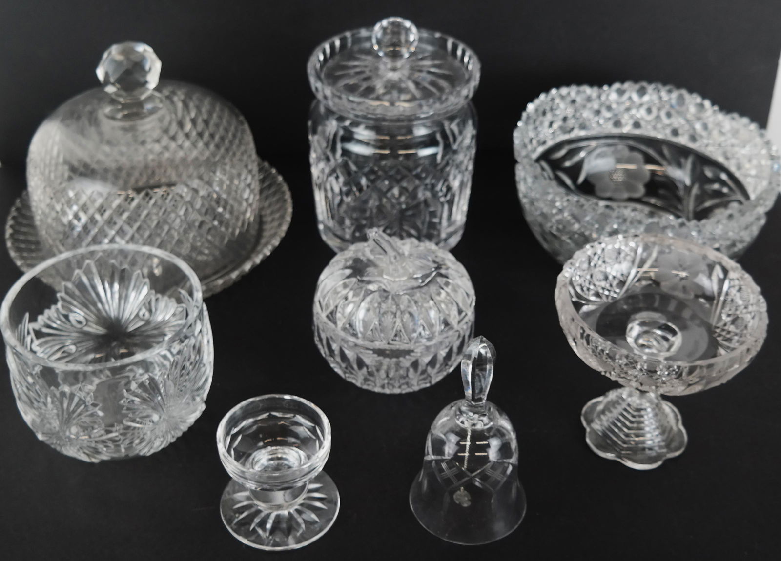 Lot of 7 Cut Crystal Table Articles: Lot of cut crystal and glass articles includes a covered cake plate, covered candy jars, bowl, bell, covered bowl and mini wine carafe. From the Estate of Florence and Herbert Irving. [Cake plate: 6 1