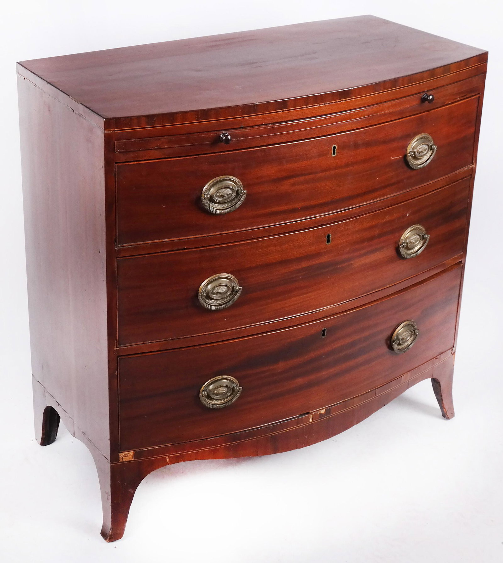 George III Period Mahogany Bowfront Chest: George III period mahogany bowfront chest, with brushing slide. Circa 1790. [35 1/2" H x 36 1/2" W x 18 1/2" D]. Losses to some inlay and beaded molding.