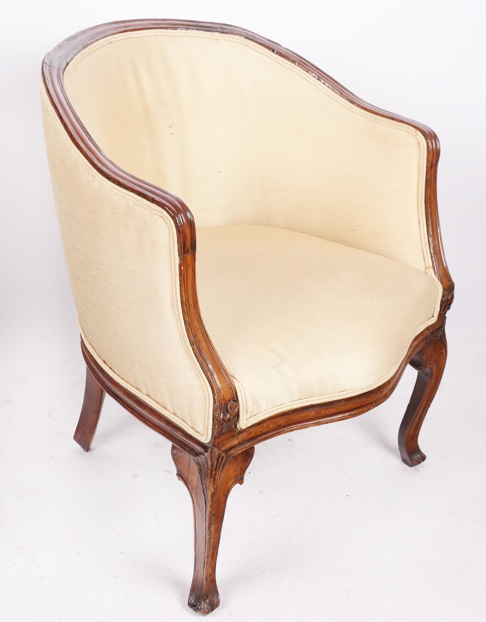 Antique French Bergere: Antique French bergere, roundabout carved with fruitwood frame. 19th century. Provenance: Estate of Florence and Herbert Irving. [26" H x 26" W x 25" D]. Upholstery as is.