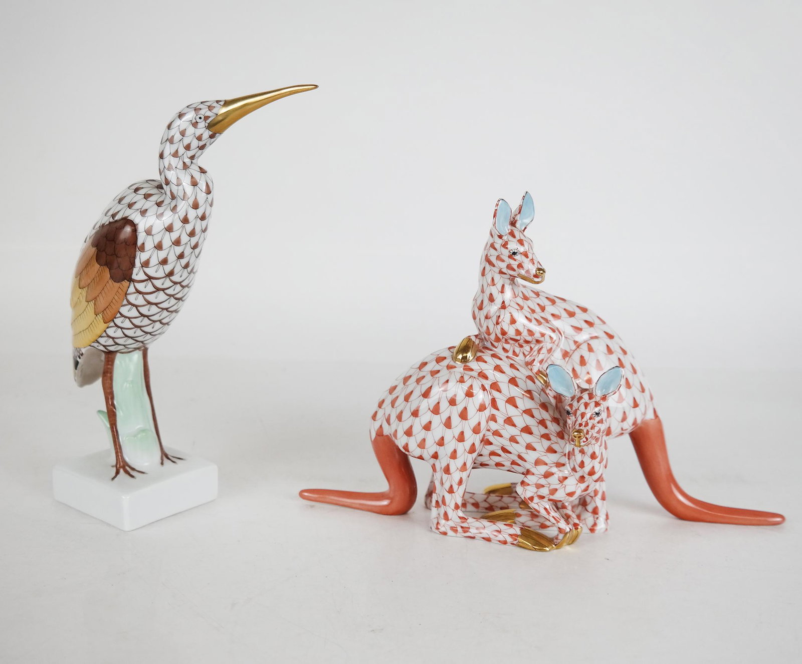 Herend Crane & Kangaroos: Herend crane [7" H], and group of kangaroos [5 1/2" H x 8 1/2" W]. With gilt trim and fishnet pattern. In excellent condition.