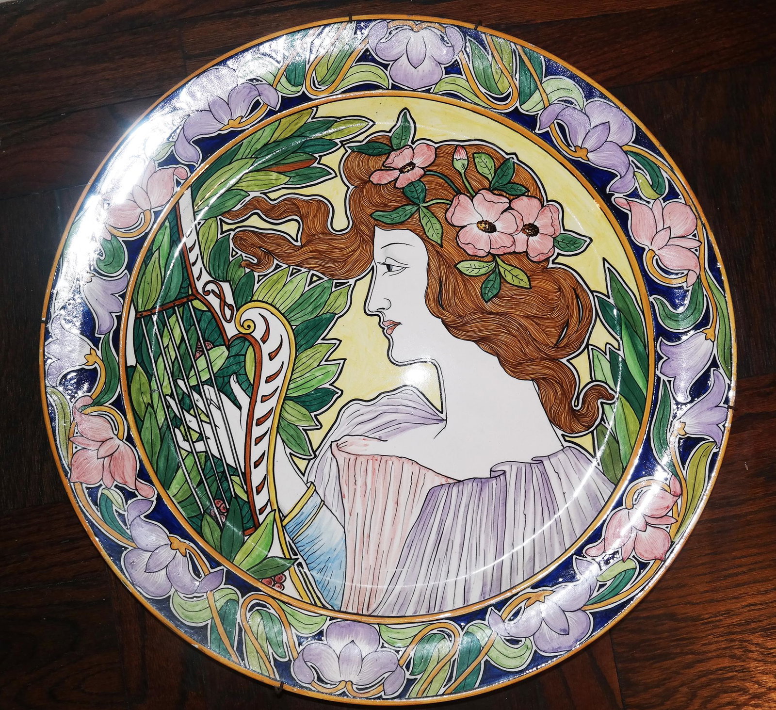 Art Nouveau-Style Charger with Woman & Harp: Art nouveau-style charger with a decoration of a woman playing a harp, porcelain. Provenance: Estate of Florence and Herbert Irving. [18 1/2" Diam.].