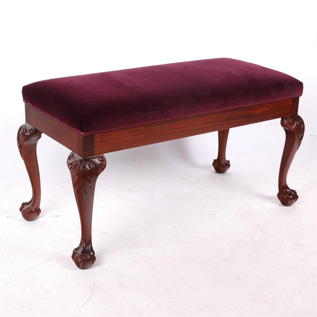 Chippendale-Style Bench: Carved mahogany ball & claw feet, upholstered in a wine color velvet, late 20th century. '21" H x 40" W x 19" D]. In good condition.