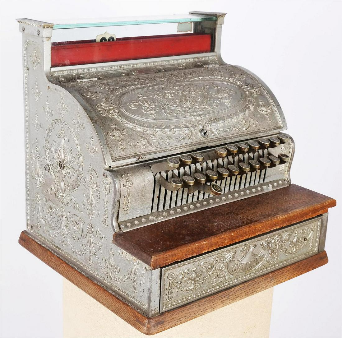 Antique Metal & Wood National Cash Register: Ornately decorated metal and wood National cash register, Dayton Ohio, Model 332, circa 1900. Not locked; no key. [17 1/2" H x 17 1/2" W x 16" D]. In good condition.