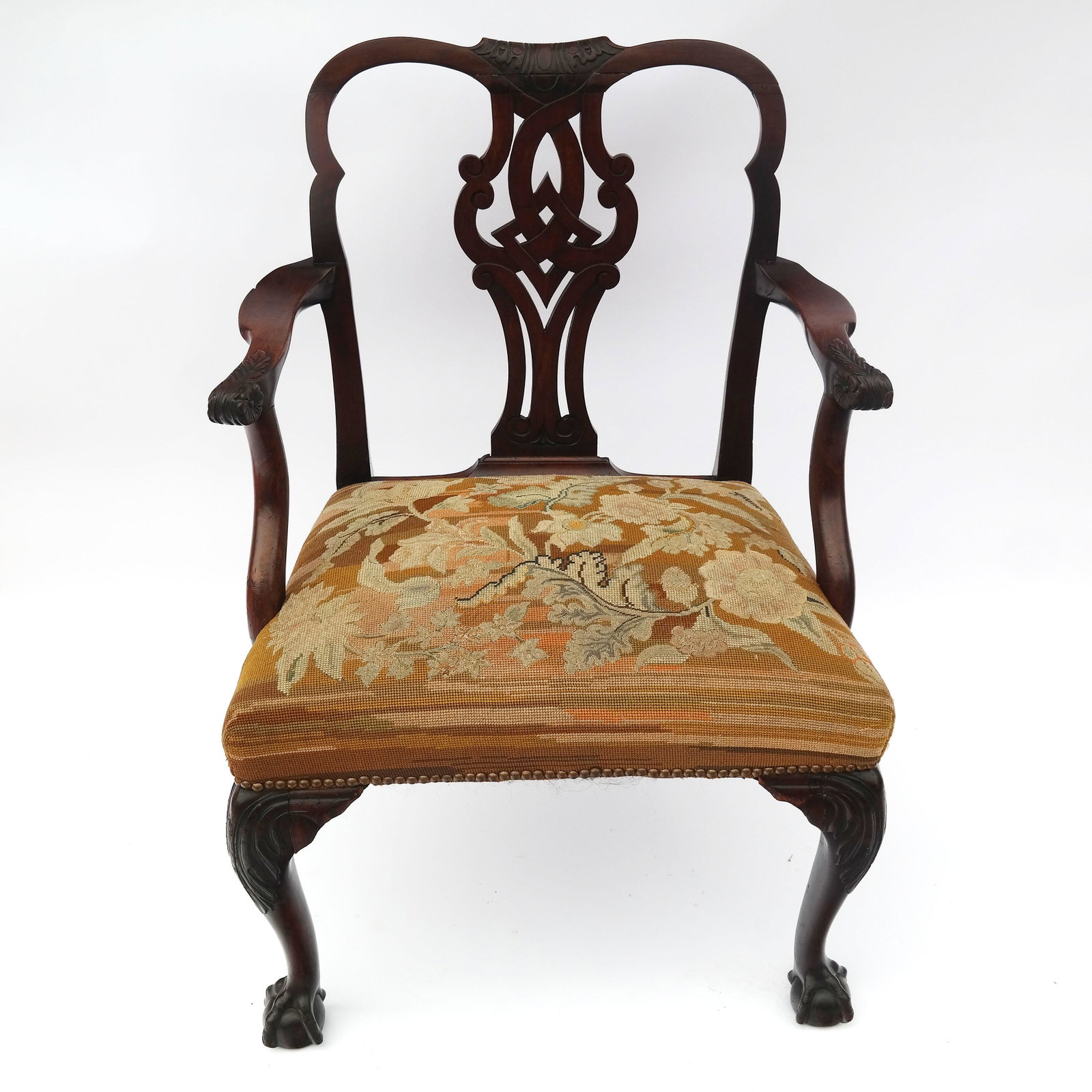 George III Period Mahogany Arm Chair: George III period carved mahogany arm chair with ball and claw feet, with antique tapestry upholstery, circa 1760. [37" H x 26" W x 21" D].