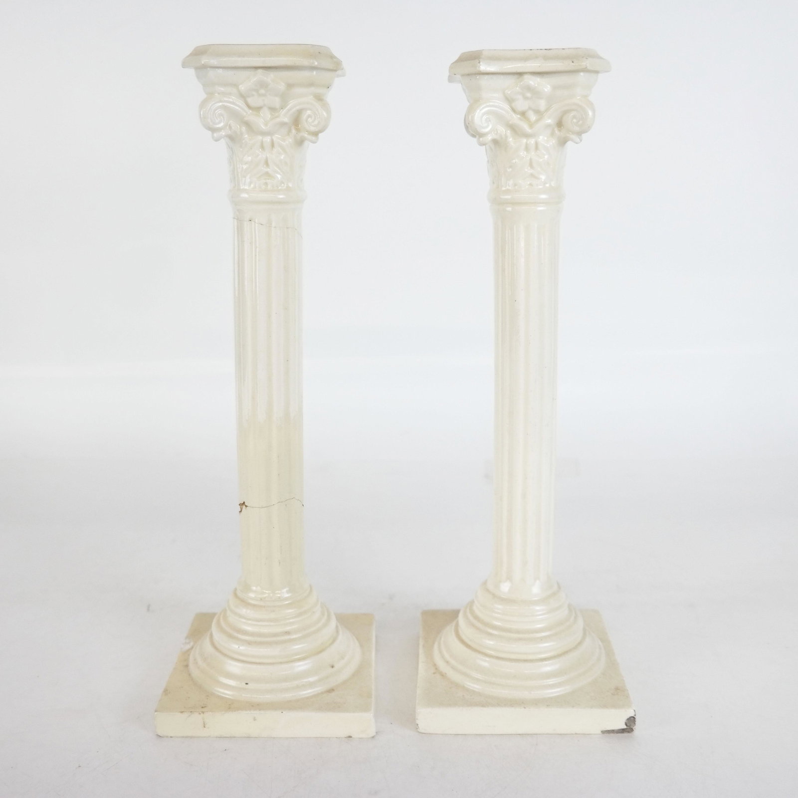 Pair of Creamware Candlesticks: Pair of Creamware candlesticks, with fluted columns. [12" H]. One as is.