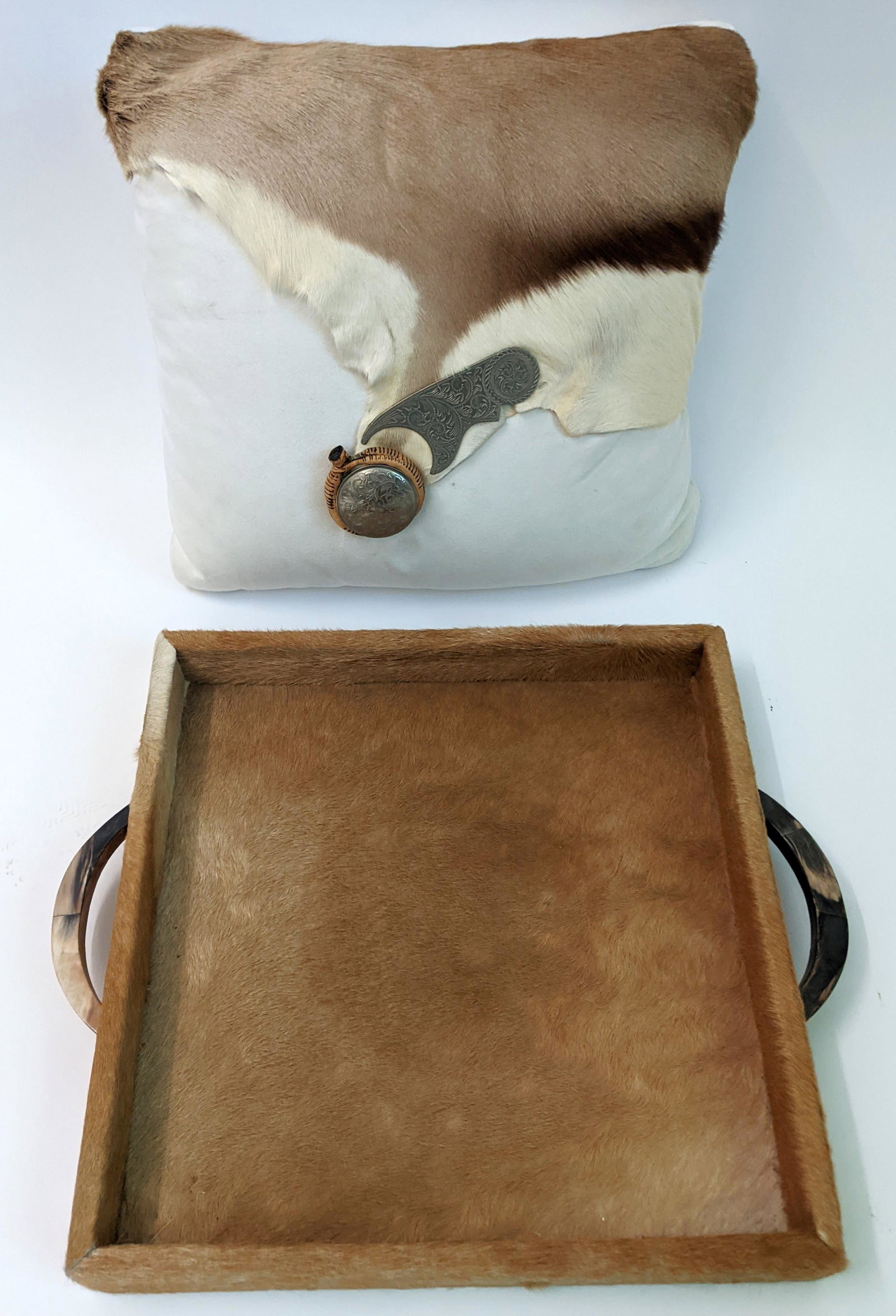 Cowhide-Handled Tray & Pillow: Cowhide-handled tray and pillow. From the Estate of June Hirsch Jones. [Tray: 16 3/8" x 16 3/8"; Pillow: 17" x 16"]. In good condition.