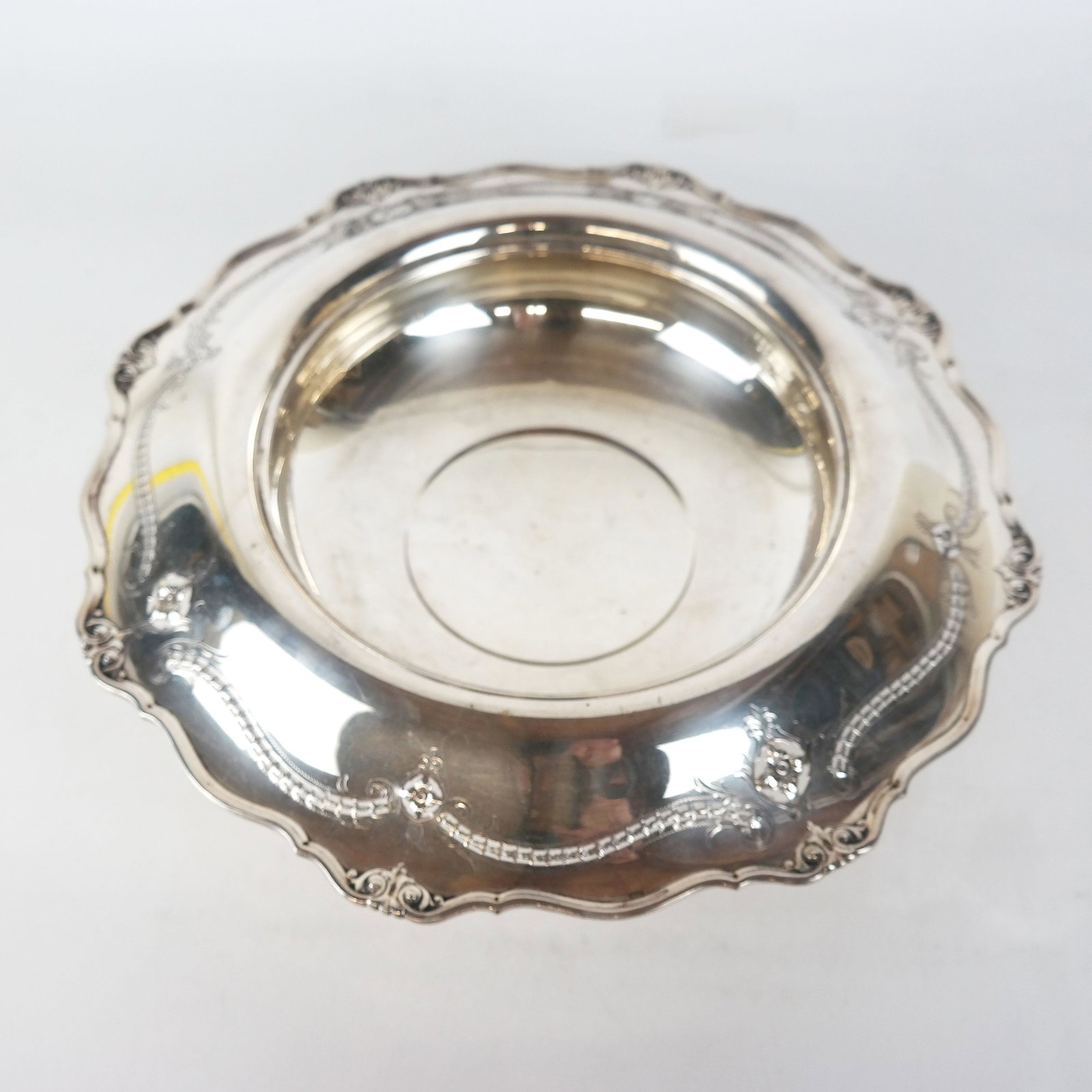 Sterling Silver Centerpiece Bowl: Centerpiece bowl with scrolling openwork border, marked, by Woodside Sterling Co. 29.0 ozt. From the Estate of June Hirsch Jones. [4" H x 14 1/2" Diam.]. Small dents.