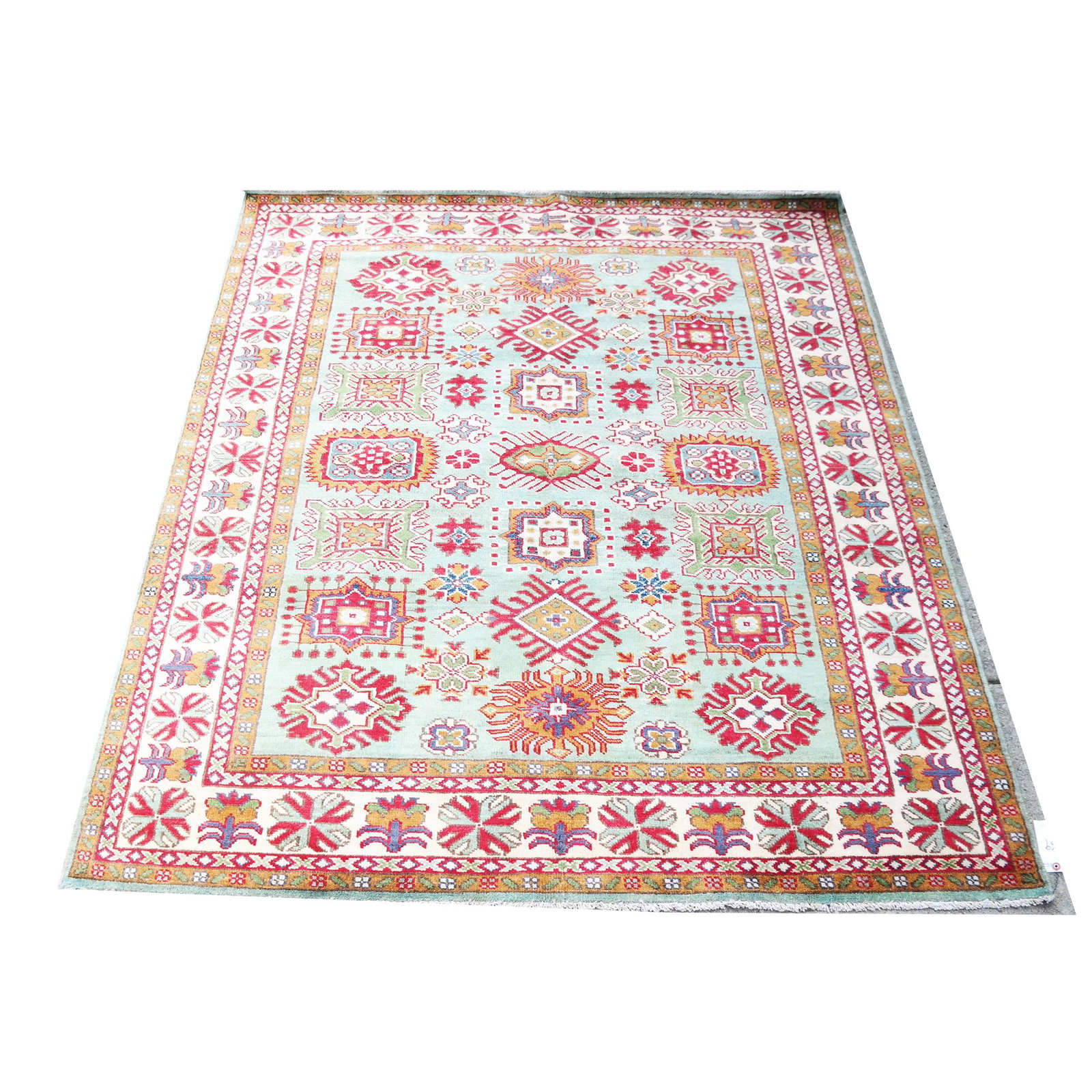 Oriental Rug: Green field with rosettes and ivory ground border. [Approx: 6 1/2' x 5'].