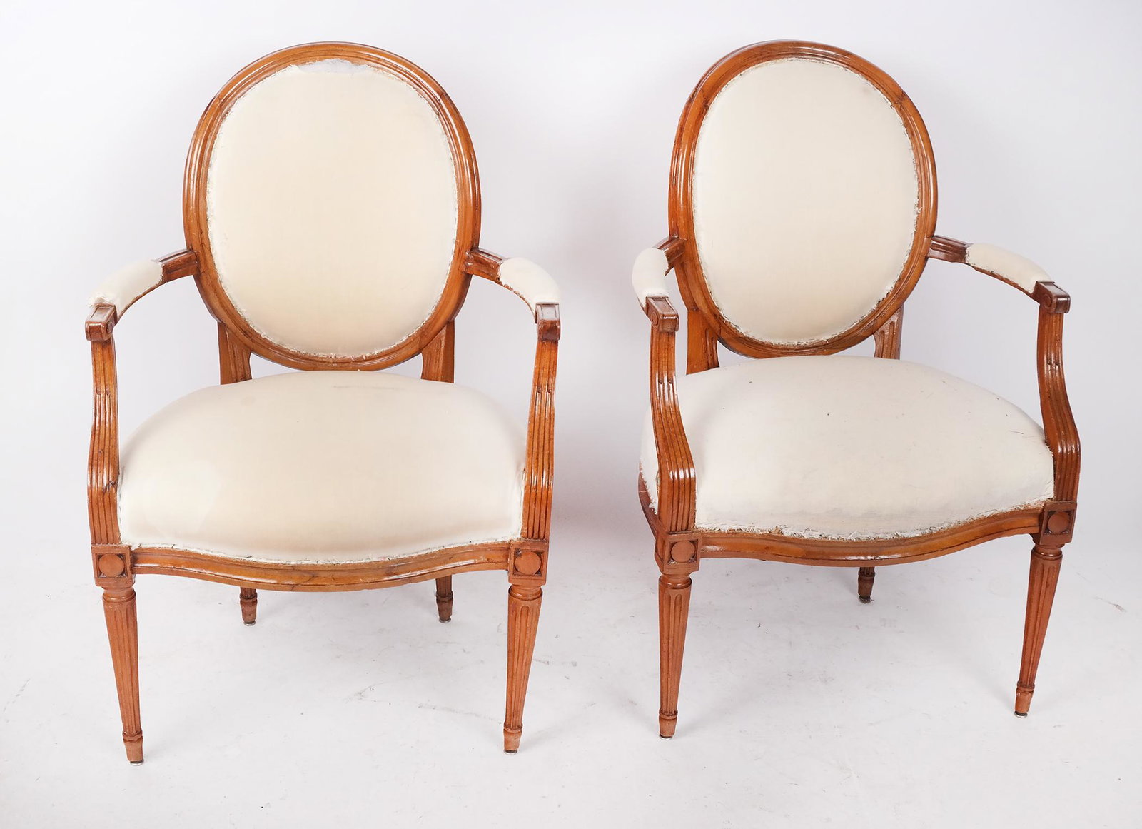 Pair of Antique French Open Arm Chairs: Pair of Louis XVI-style arm chairs with Muslim upholstery. [36" H x 23" W x 20" D].