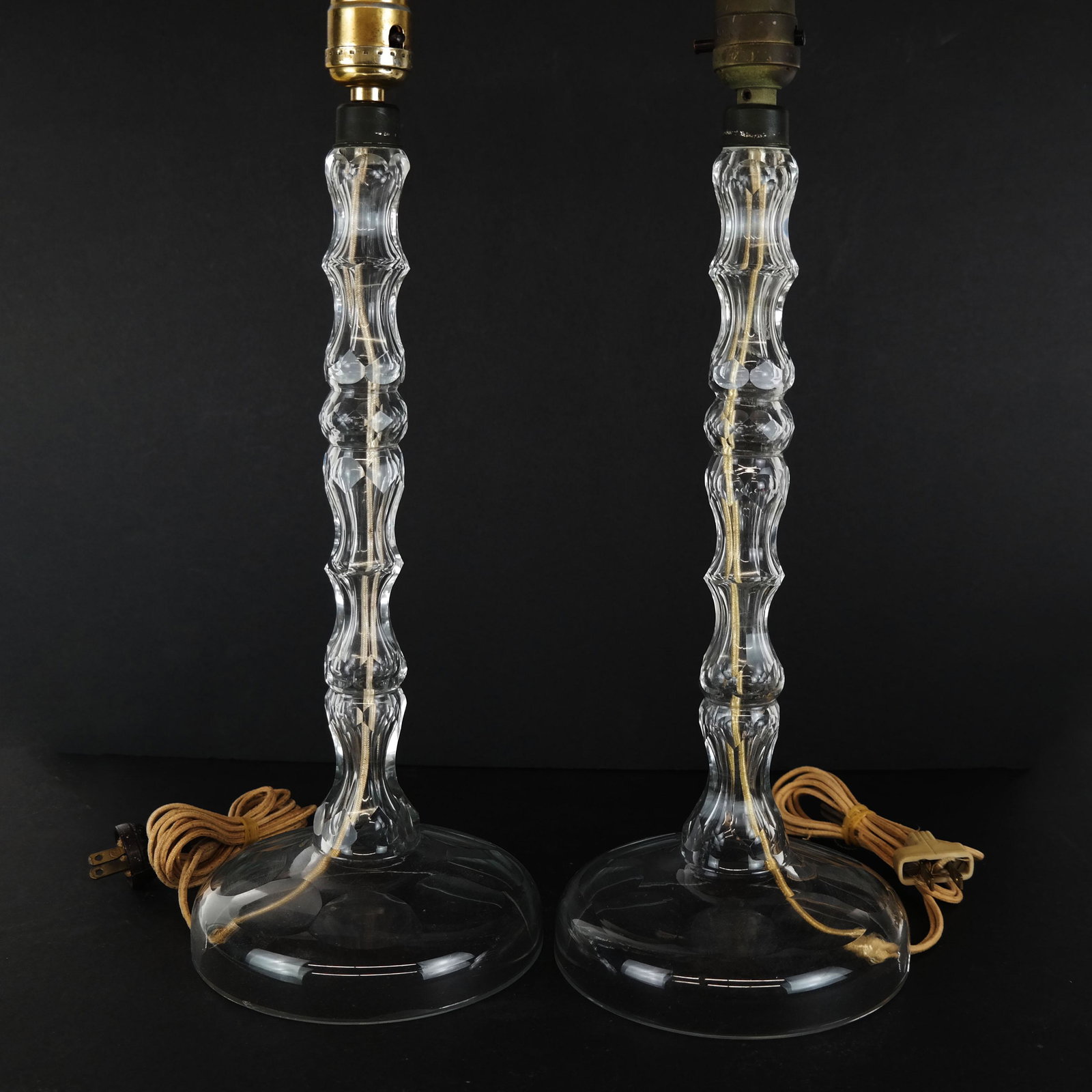 Pair of Cut Glass Candlestick Lamps: Pair of candlestick lamps, each on a wide base with cord hole, and cut glass columns. [26" H x 6" Diam.]. In good condition.
