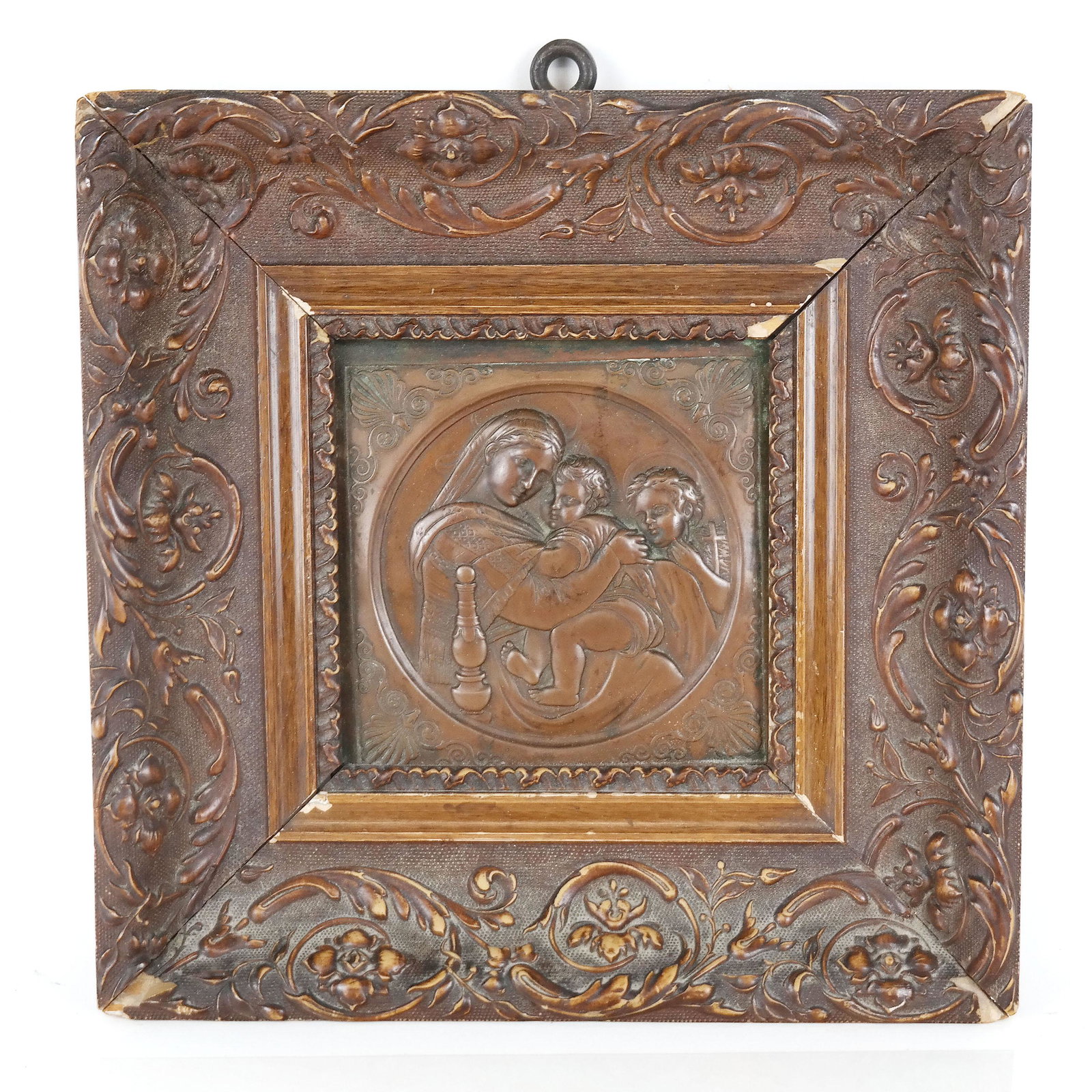 19th C. Framed Bronze Religious Relief: European 19th century cast bronze relief, after Raphael, of tondo shape design with foliate and shell corners, depicting the Madonna with the Christ child and St. John the Baptist. Not signed. Molded 