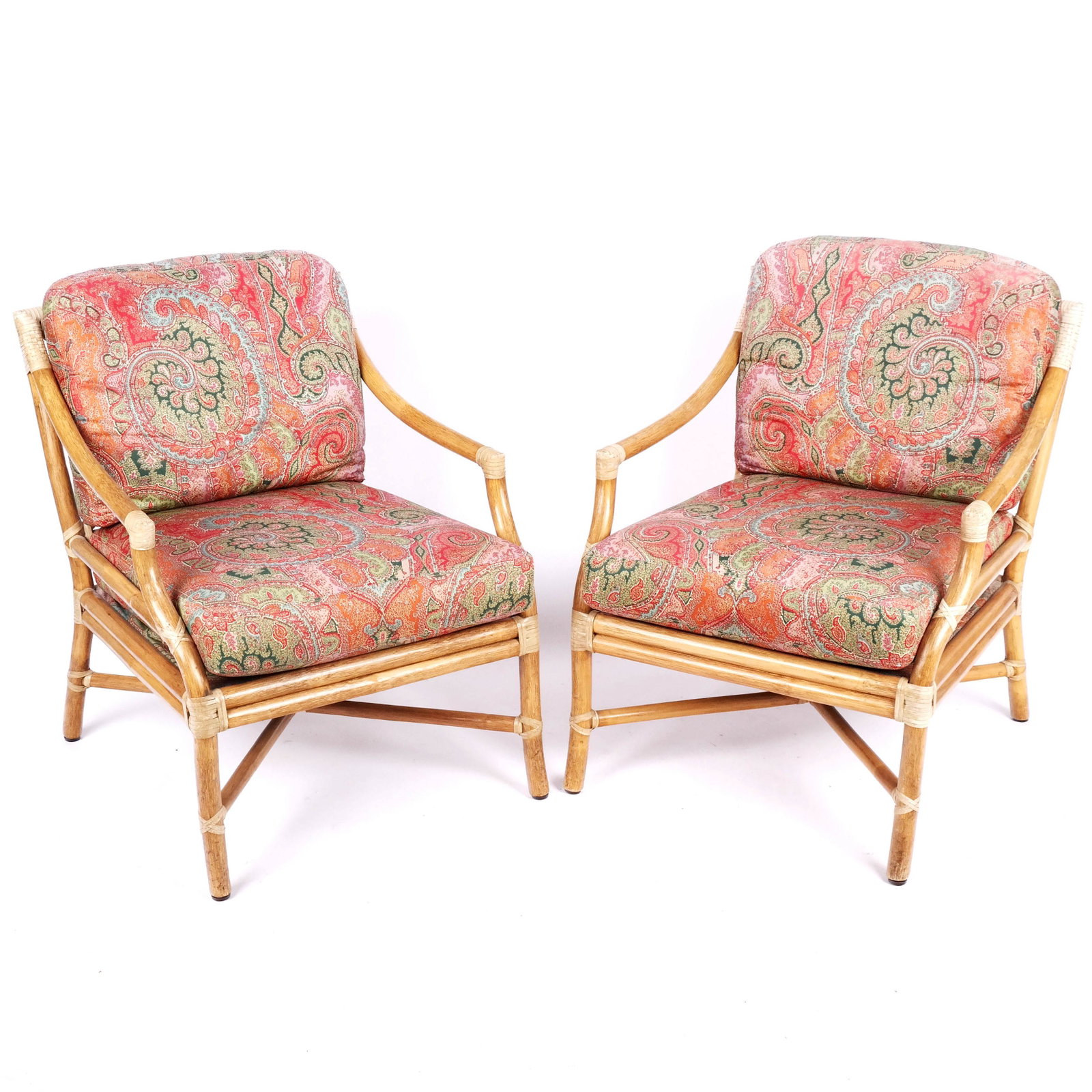 Pair of Bamboo & Rattan Club Chairs: Pair of bamboo and rattan club chairs, with pad upholstered pillows. [29" H x 25" W x 34" D]. In good condition.