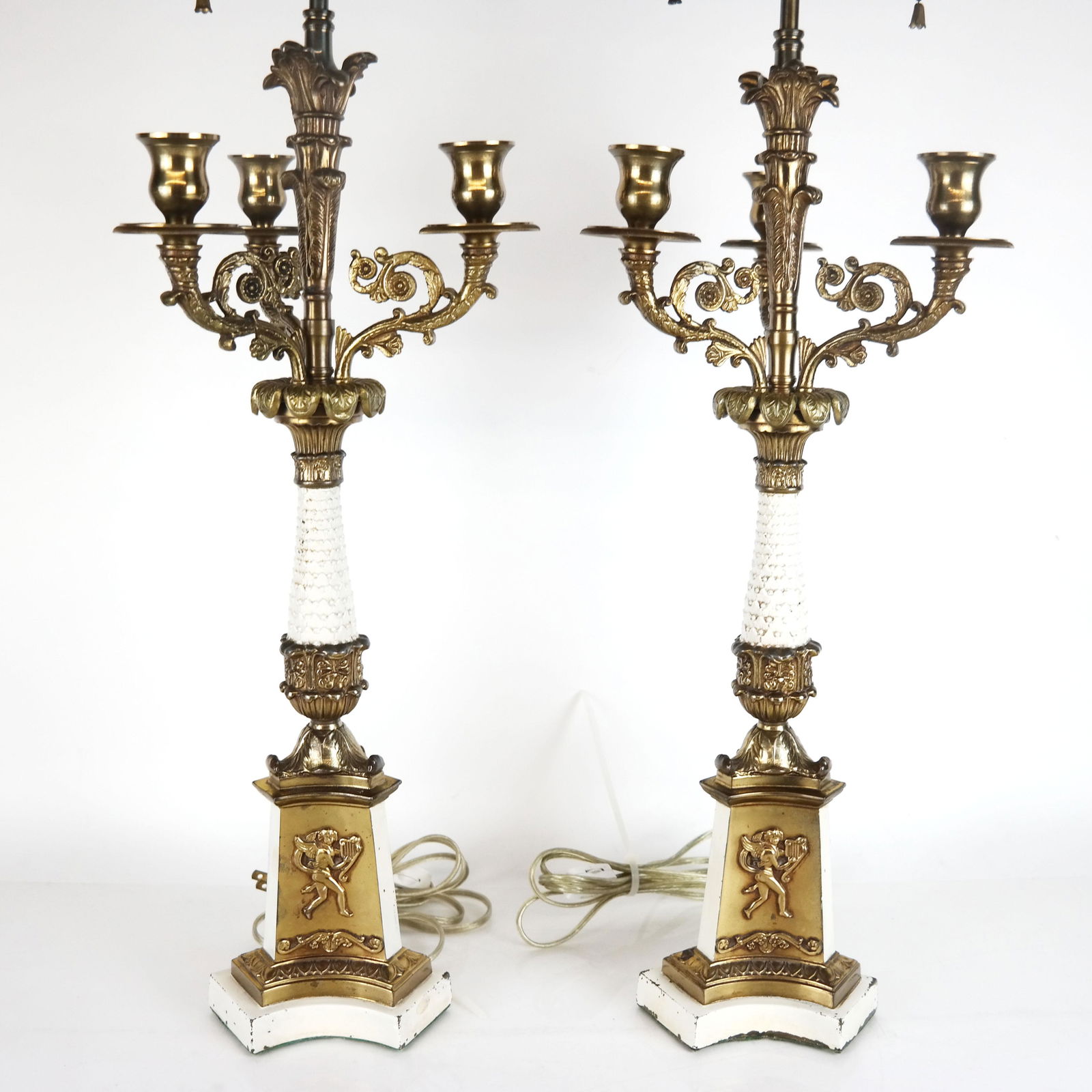 Pair of 5-Light Candelabra Table Lamps: Pair of Continental cast brass and painted metal 5-light candelabra, with acanthus and scroll motifs, having cherubs with harps in relief at bottom and wreath finials at top, converted into table lamp
