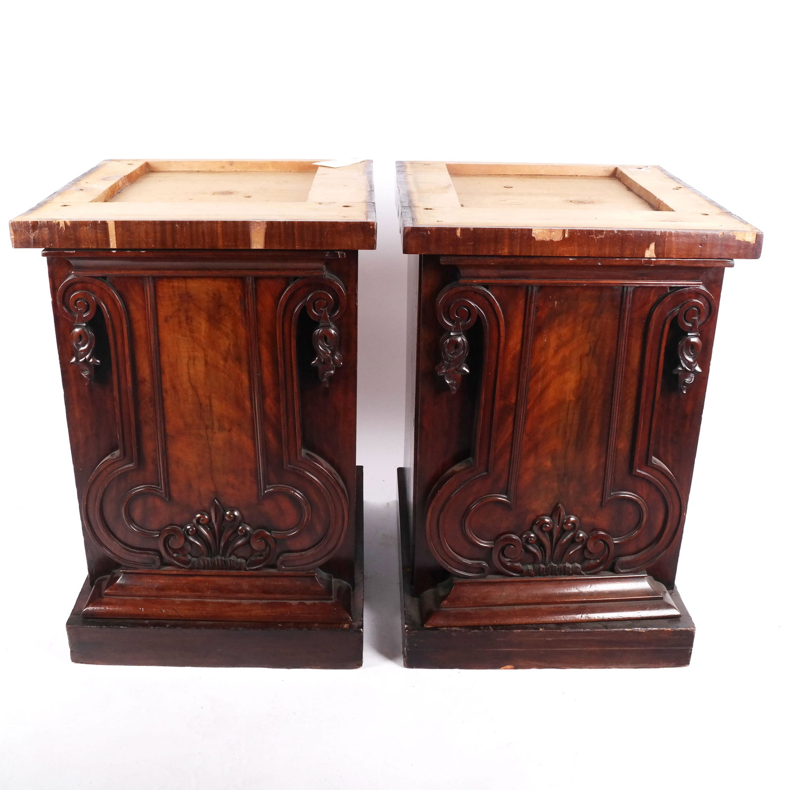 Pair of Antique English Mahogany Pedestals: Mid-19th century English mahogany pedestals, the right hand door with interior open drawers, the left hand door with one shelf. Panel doors with carved mounts. Formerly from a sideboard. No tops. [Eac