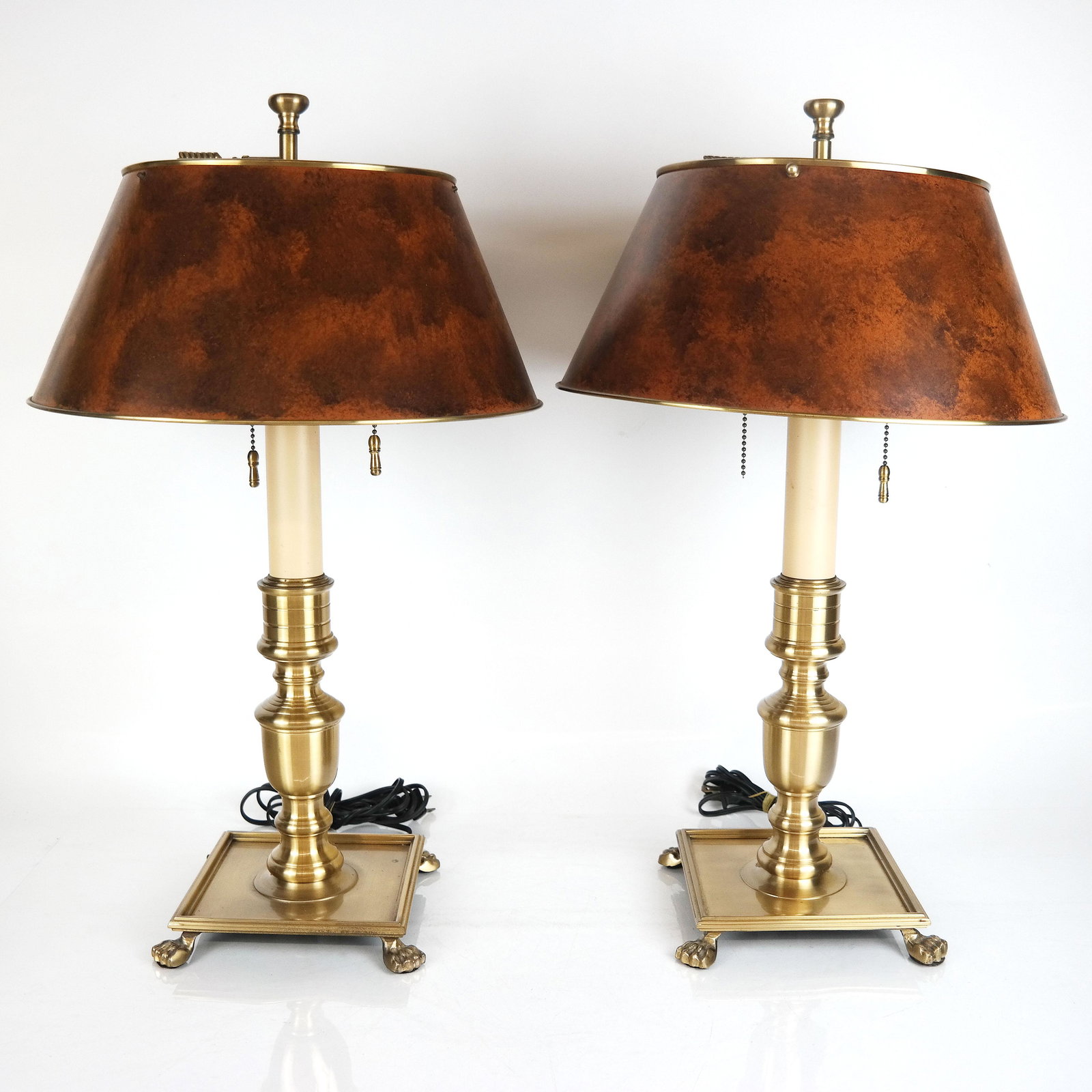 Pair of English-Style Brass Lamps: Pair of modern polished brass column lamps with tole shades. [24" H x 13" Diam.]. In good condition; not tested.