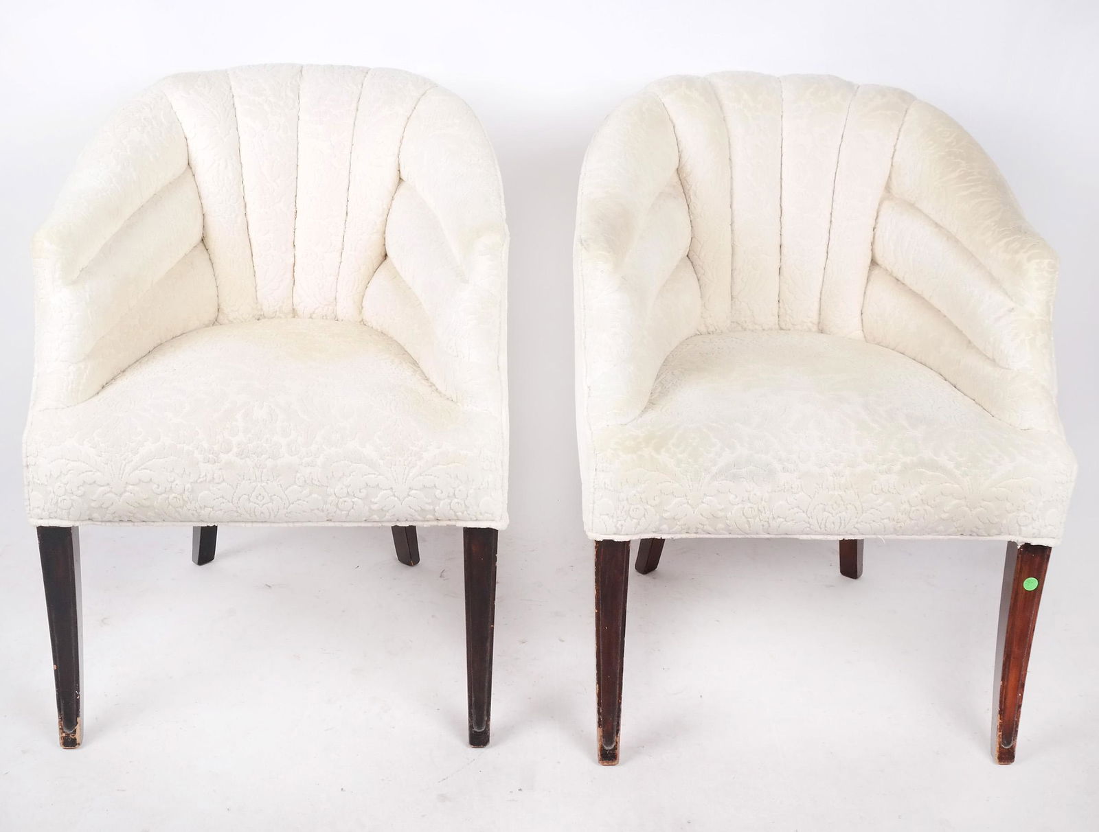 Pair of Art Deco-Style Club Chairs: Pair of art deco-style club chairs in roundabout-style with channeled fabric upholstery, on sabre legs From the Estate of June Hirsch Jones. [33" H x 26" W x 27" D]. Wear.