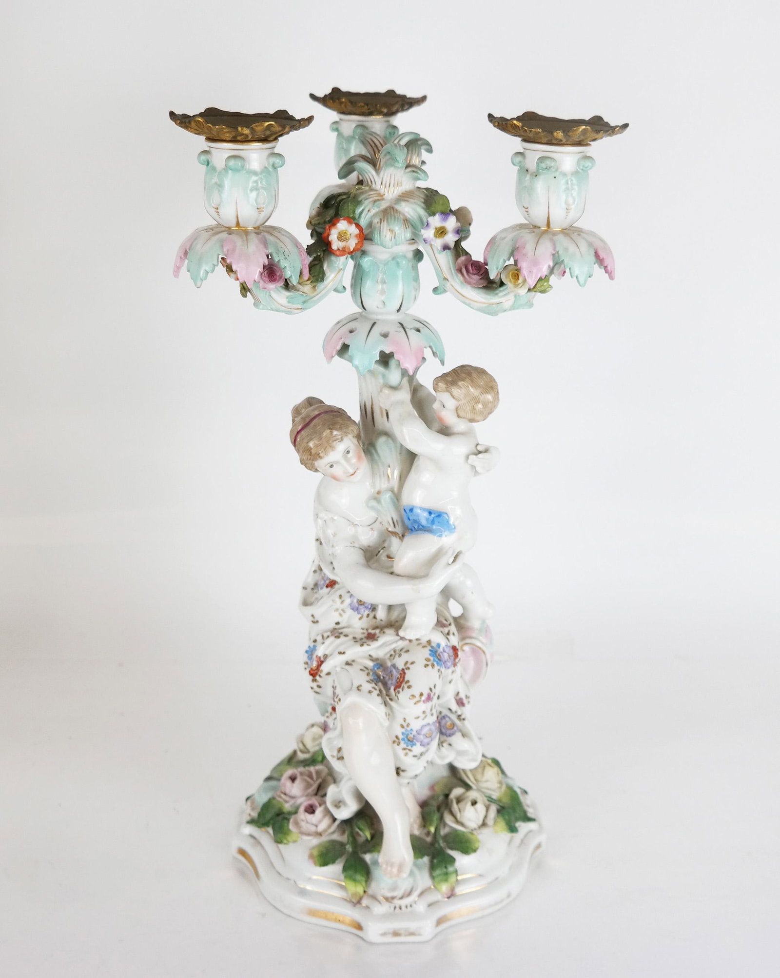 Meissen, Germany Single Porcelain Candelabra: Meissen, Germany single porcelain candelabra, with a figure of a mother and child. [Overall: 15" H x 8" Diam.; Base: 13" H]. Overall good condition.