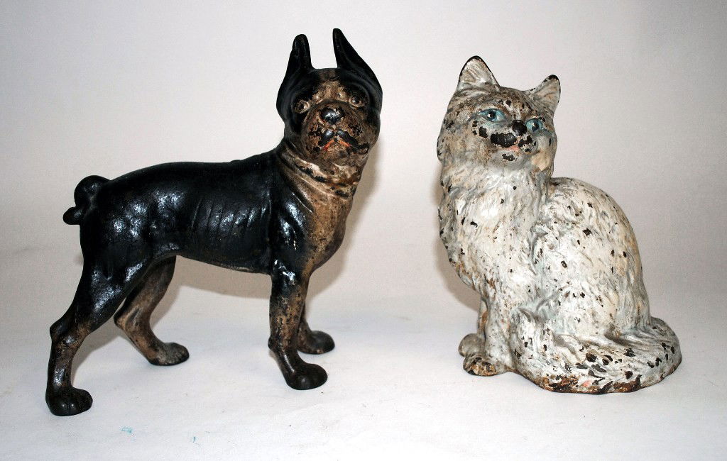 Bull Dog & Cat Door Stops: Two sculptural cast iron door stops, one depicting a bull dog, the other a cat. Bull Dog- 4-1/4"W x 10"D x 9-3/4"H. Cat- 6-1/2"W x 4-1/2"D x 8-3/4"H