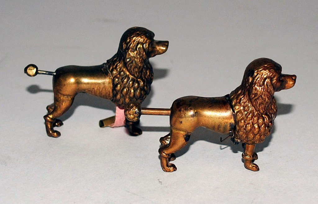Tobacco: Two Antique Brass Mechanical Poodles: Two Antique Brass Mechanical Poodles. Nearly identical to each other, one opens to reveal a tape measure, while the other, a cigar cutter. 3/4"W x 2-1/2"D x 1-1/2"H . One w/ Tail Repaired.