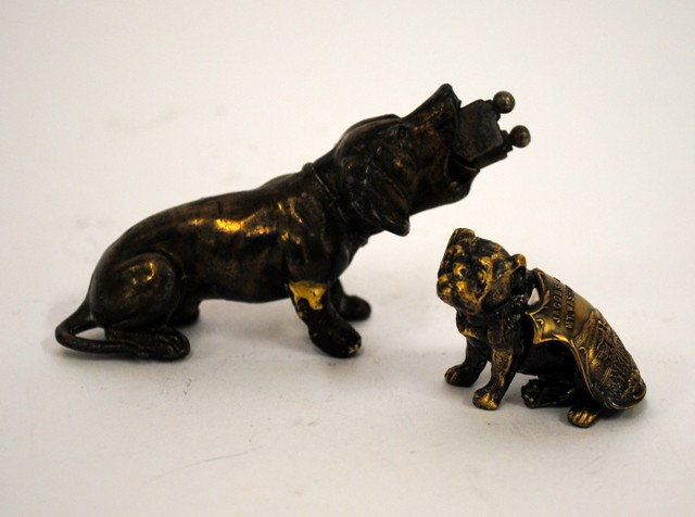 Tobacco: Two Bronze Dog Form Cigar Cutters: Two Bronze Dog Form Cigar Cutters. Comprises a Daschund and Bull Dog with "Washington R.R." Shield. Dauschound: 1-1/4"W x 3-1/2"D x 2"H. Bull Dog: 1"W x 1-1/2"D x 1-1/4"H