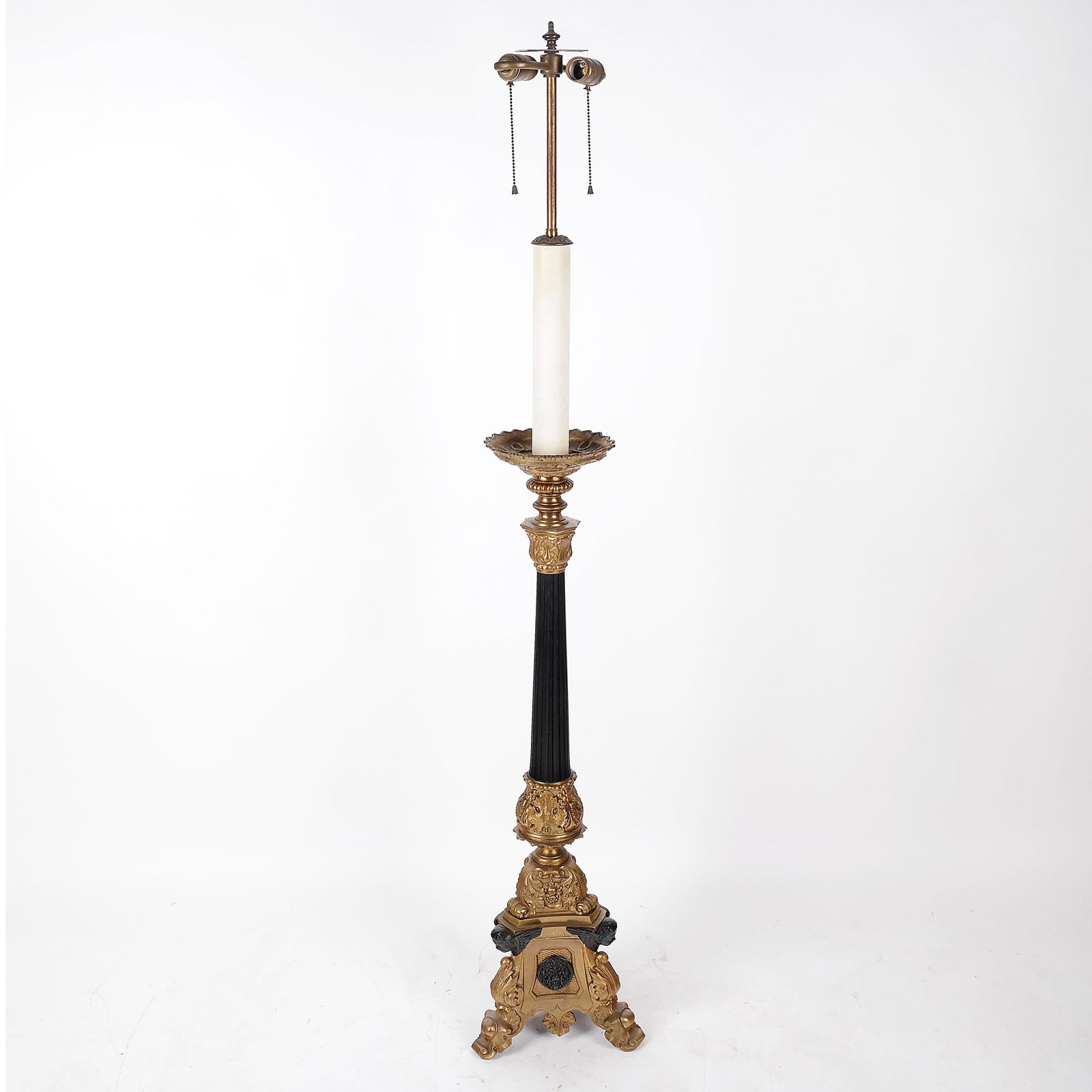Renaissance-Style Altar Stick Floor Lamp: Gilt and ebonized metal stick floor lamp with bobeche top on fluted column ending in capitals, on tripod base. [58" H x 9" Diag.]. In good condition.