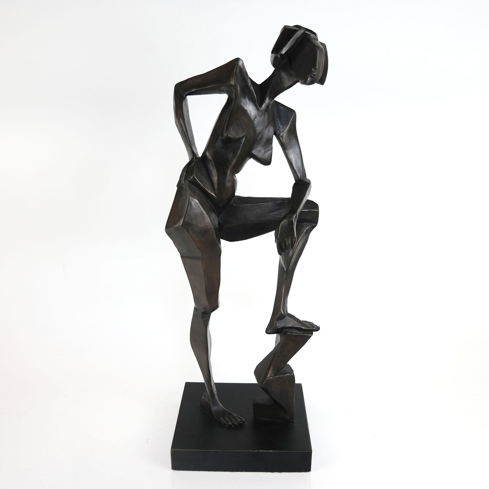 Cubist Manner Sculpture of Nude Woman: Cubist manner bronze sculpture of a nude woman, with foundry mark and numbered 1/5 to base, on a black plinth. [Overall: 18 3/4" H x 7 1/2" W x 6" D]. Minor wear and rubbing; small losses to base.