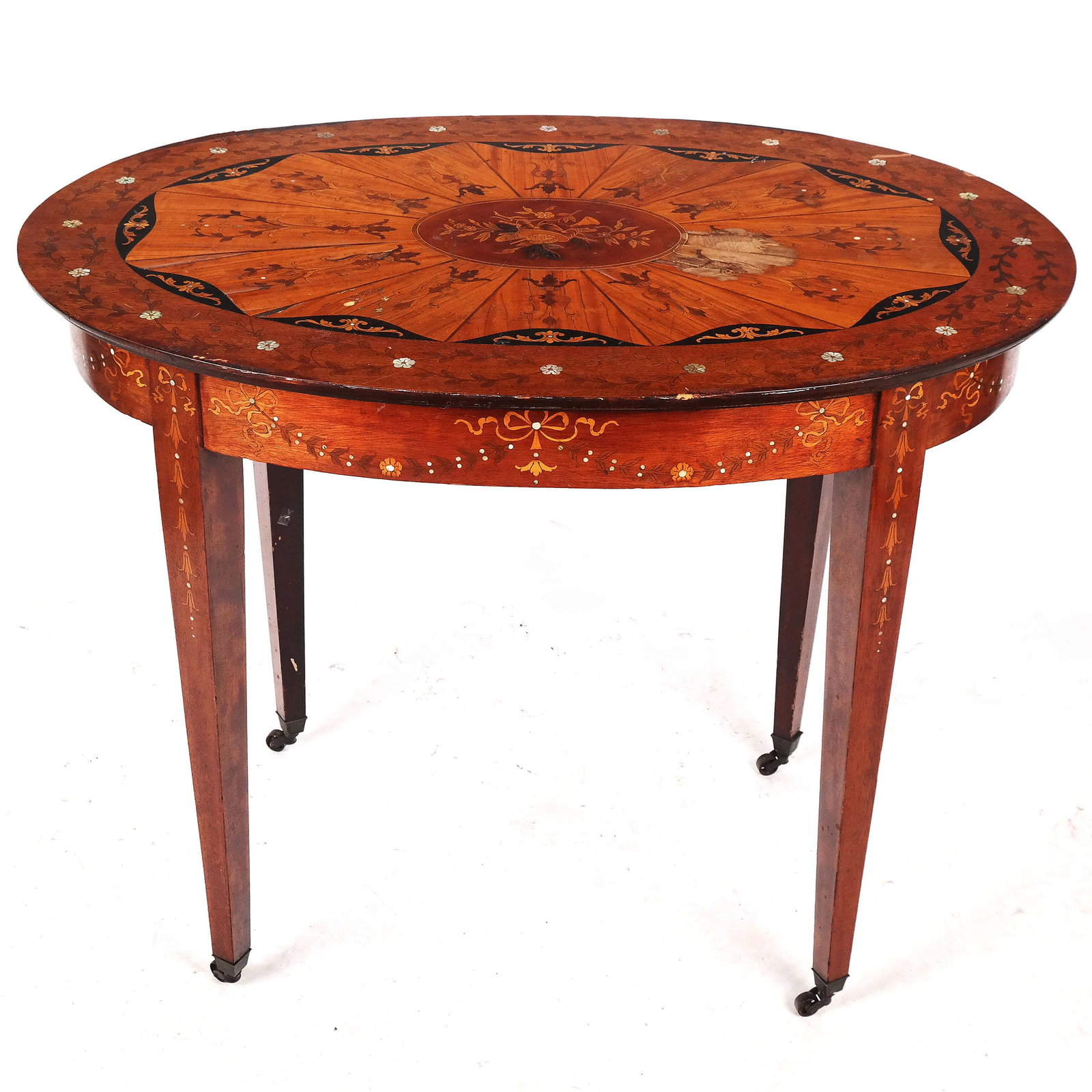 Georgian-Style Inlaid Table: Georgian-style inlaid table of oval outline, the top centered with a musical trophy and overall with floral and scrolling motifs. [30" H x 38" W x 26" D]. Stains and losses to veneers; overall with sc