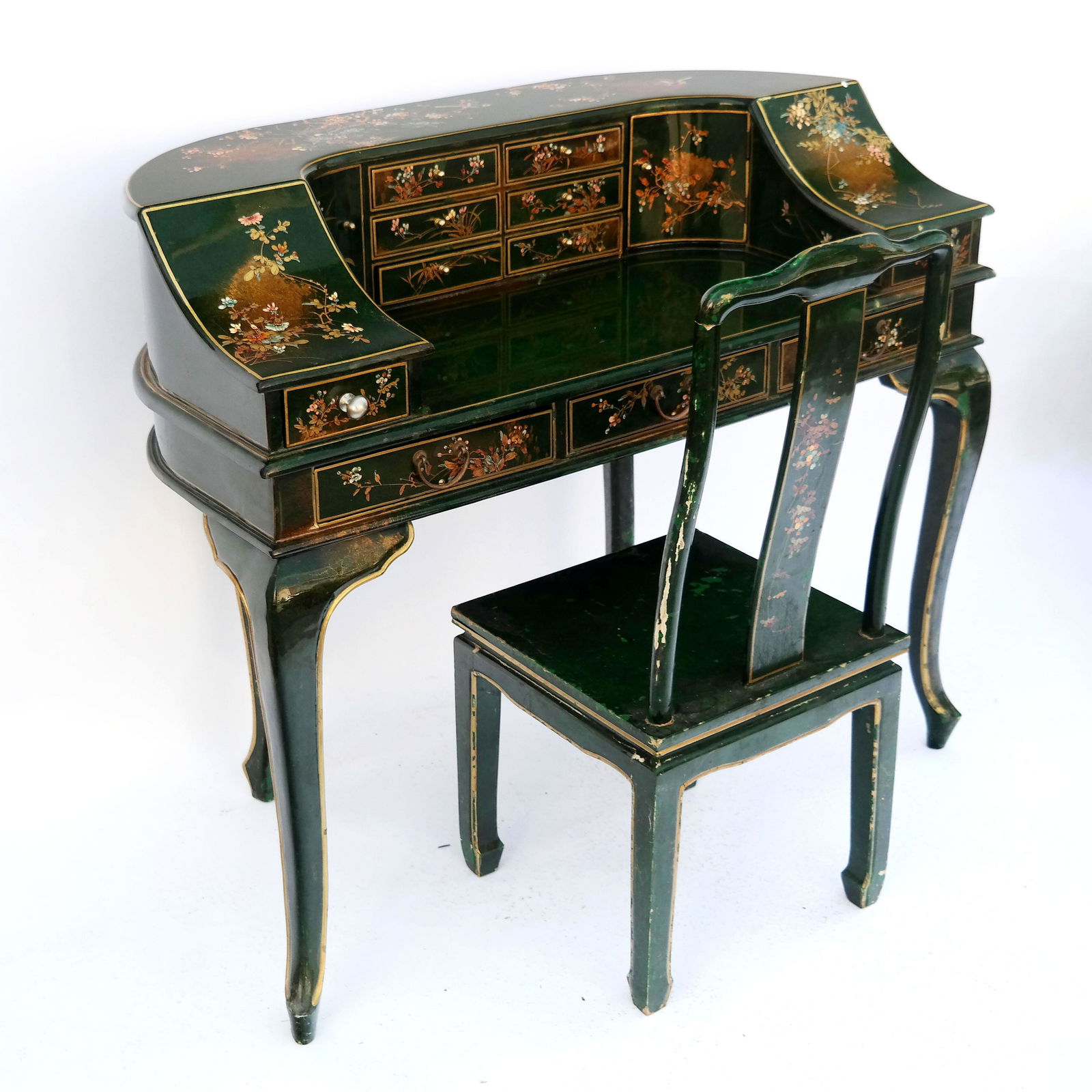 Chinoiserie Carlton House Desk and Chair: Chinoiserie green lacquer Carlton House desk and chair with bird and floral decoration. [41" H x 48" W x 24" D]. Desk with losses to lacquer, especially to legs; chair with losses and wear.