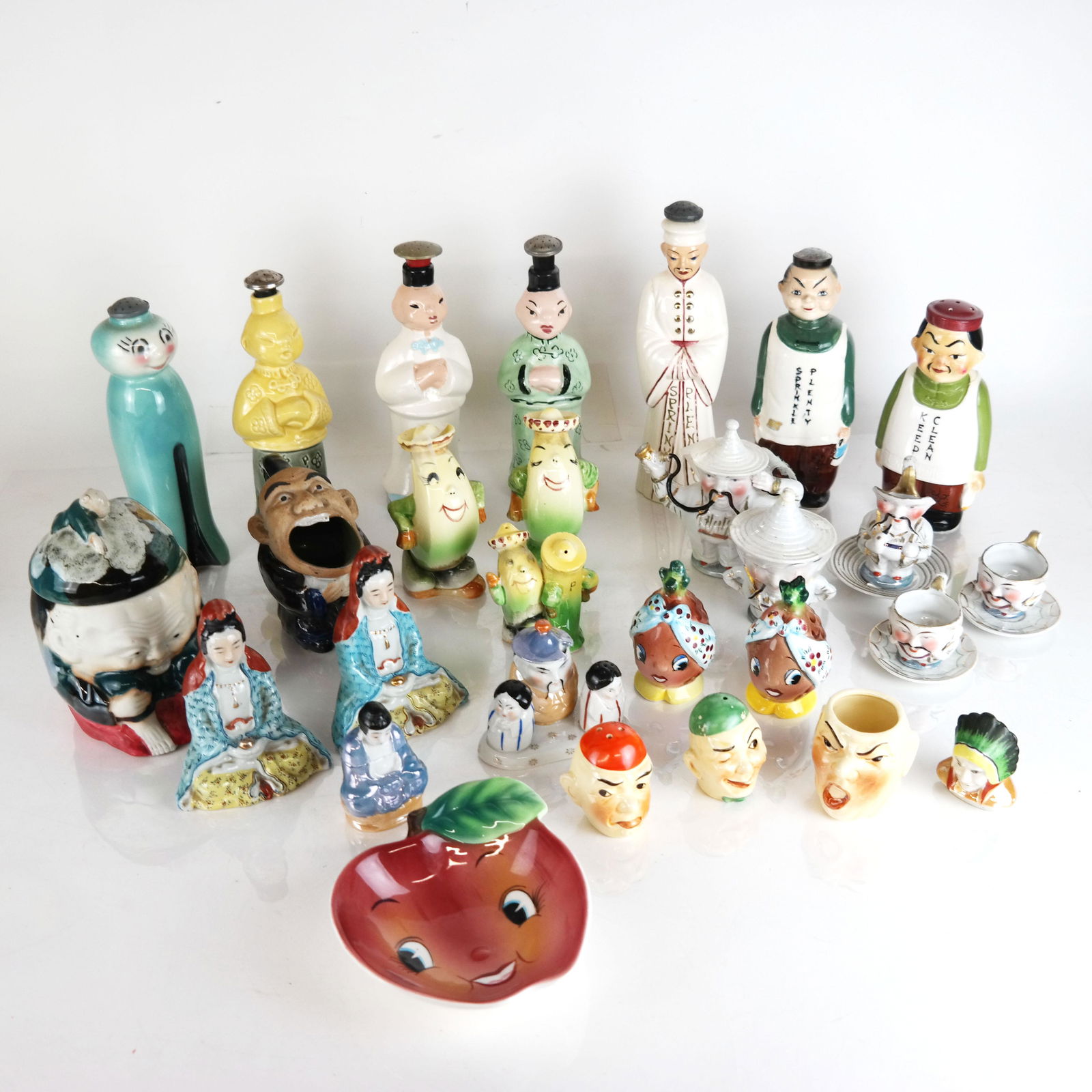 Assembled Group of Figural Casters & Shakers: Assembled group of figural casters and shakers, including ceramic and porcelain examples, some marked. [Tallest: 9 1/2" H]. Some with residue, cracks, incomplete, chips, wear, losses; some lacking sto