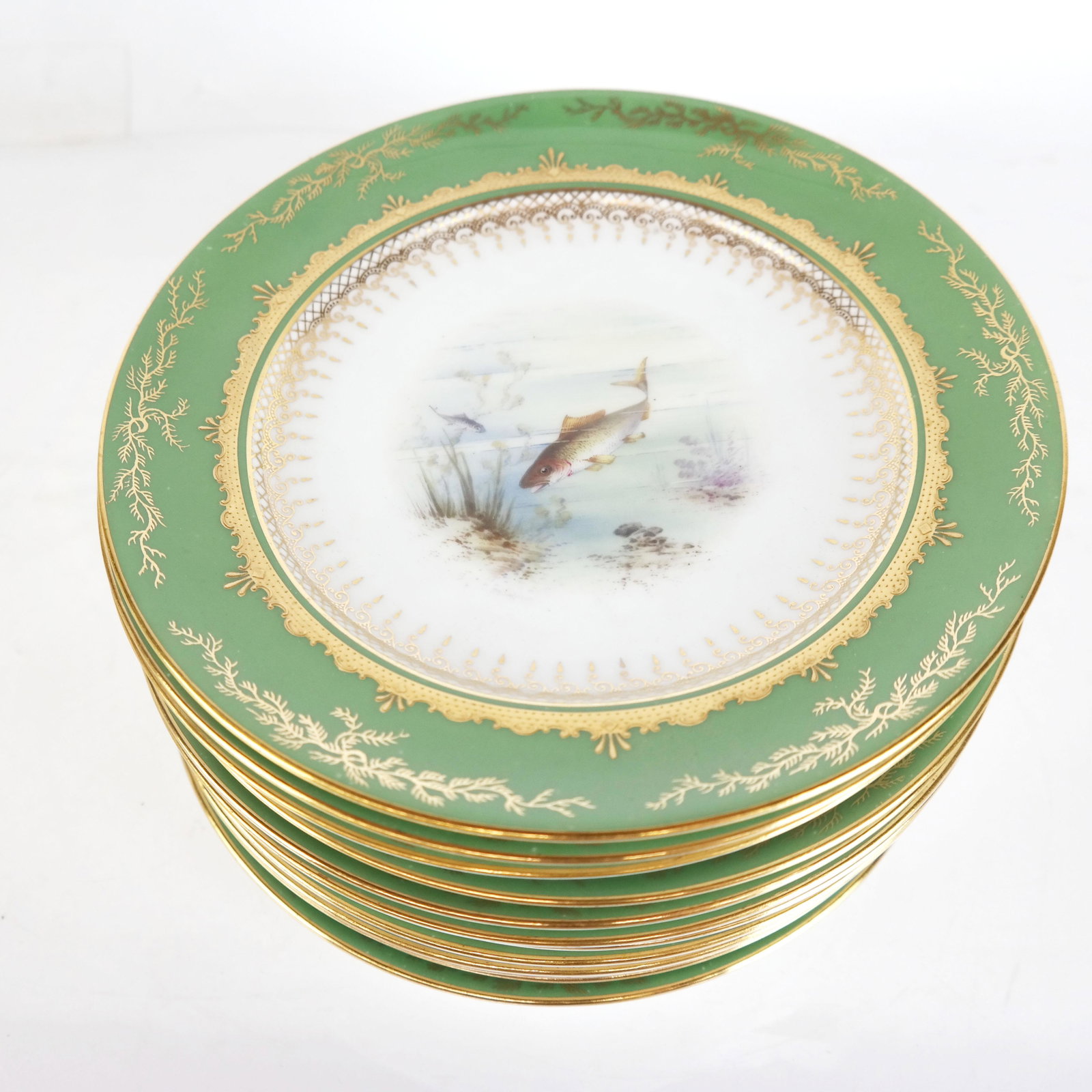 Set of 12 Coalport Fish Plates: Set of 12 Coalport fish plates, hand painted with various fish, green borders, and gilt trim. [9" Diam.].