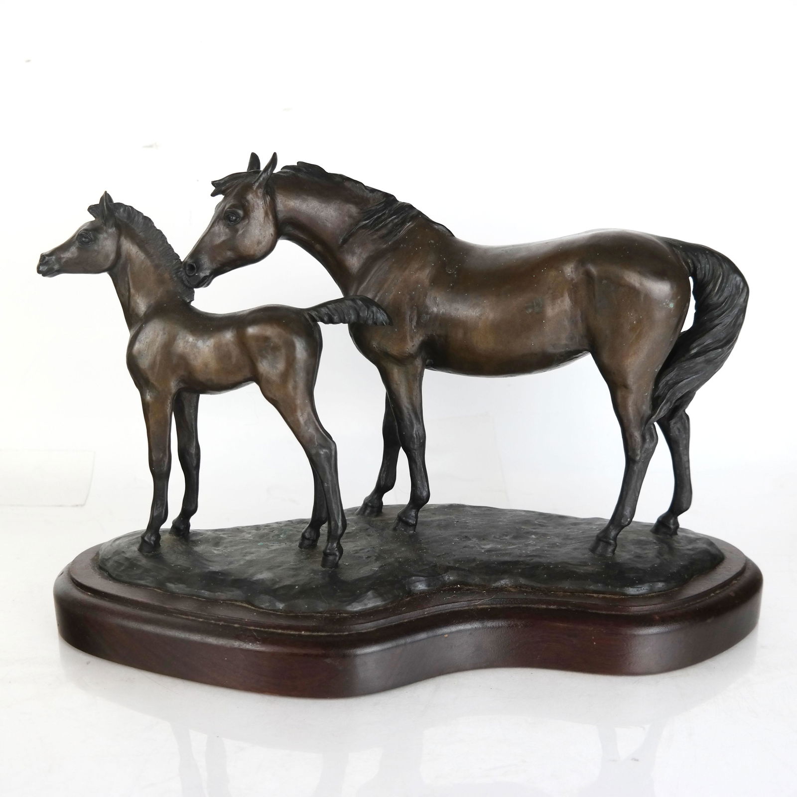 B.J. Martin Bronze of Two Horses: B.J. Martin bronze of a mare and foul. Signed, dated 1984, edition 4/18. On wood base. [9" H x 14" W x 7" D].