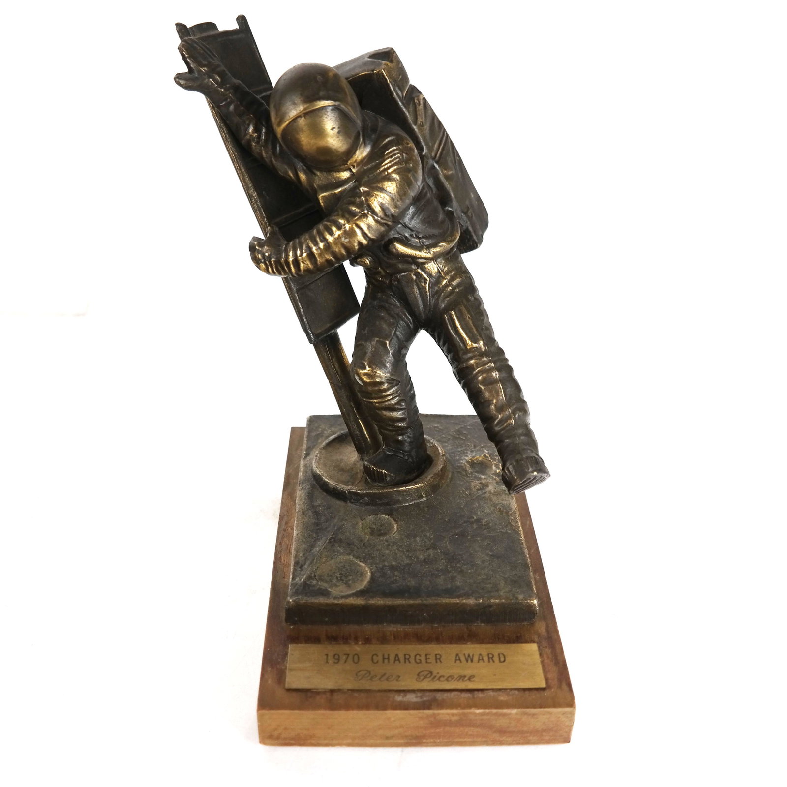 Signed Bronze Astronaut Trophy: Bronze astronaut by a ladder, signed Redechini (?). 1970 Charger Award, on wood base. [9" H x 8" W x 6" D].