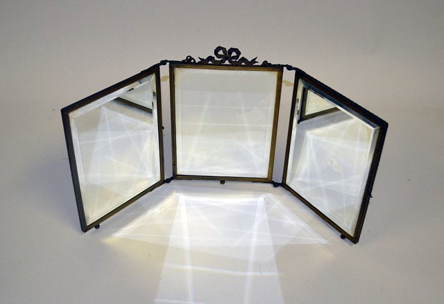 Antique Louis XVI Style Triptych Vanity Mirror: Antique Louis XVI style triptych vanity mirror with bronze accents. Features original hand-beveled mirror panels.
