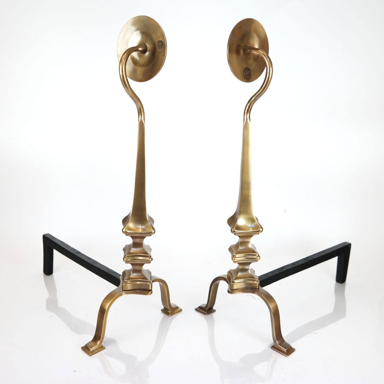 Pair of Art Deco-Style Andirons: Pair of art deco-style andirons with disc tops on shaped posts, brass. [24" H x 10" W x 16" D].
