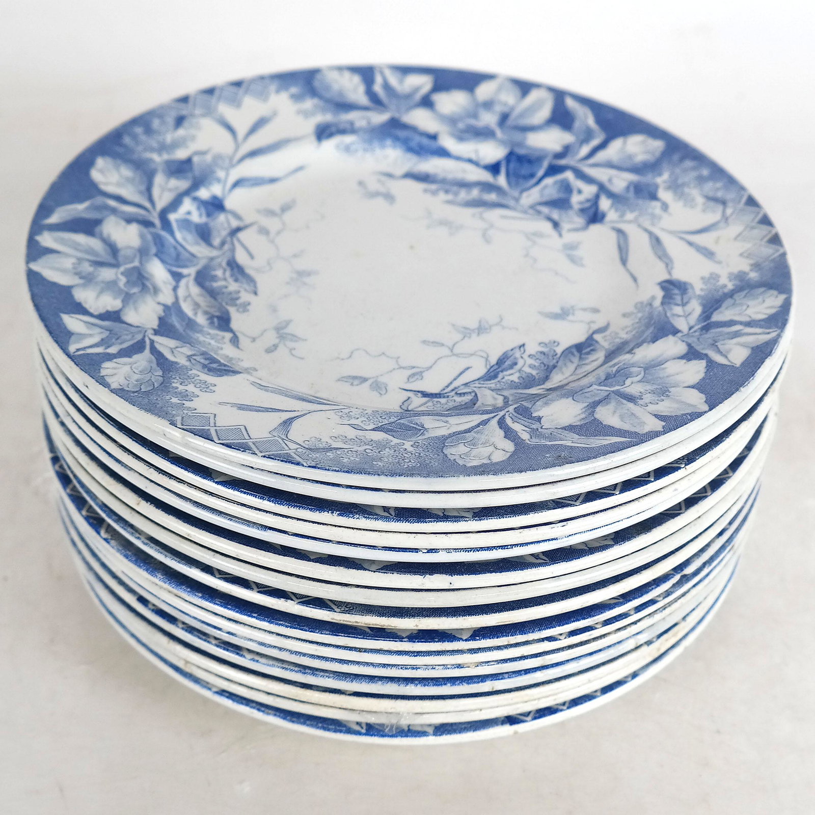 Set of 15 Camelia Depose Plates: Blue on white transferware flora design plates. Provenance: From the Upper East Side estate of a prominent NYC interior decorator. [8" Diam.].