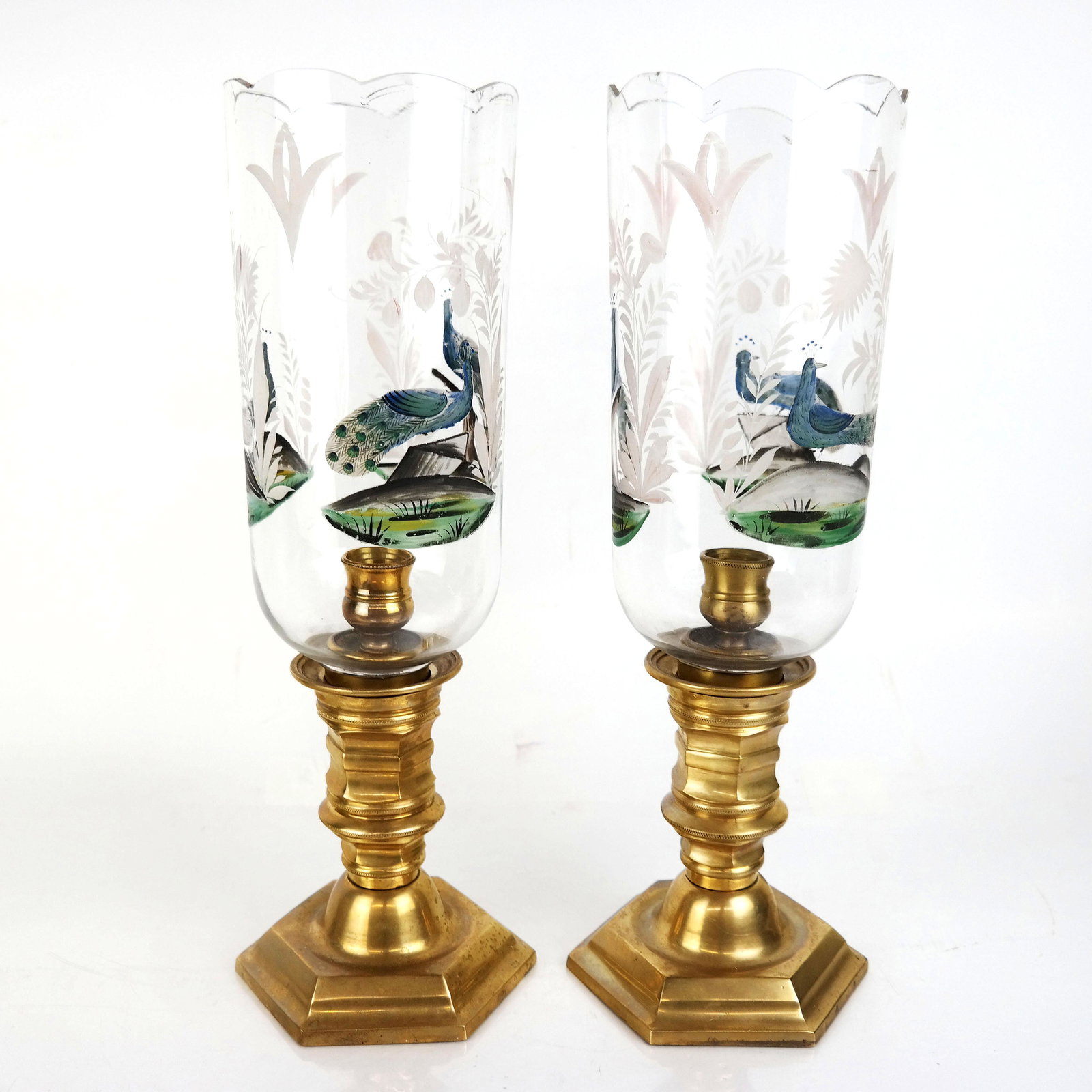 Pair of Victorian-Style Photophores: Pair of Victorian-style photophores, possibly English, each having a clear glass shade paint-decorated with peacocks and scalloped rim over the candlestick base. [16 1/2" H x 6" Diam.]. Small chips to