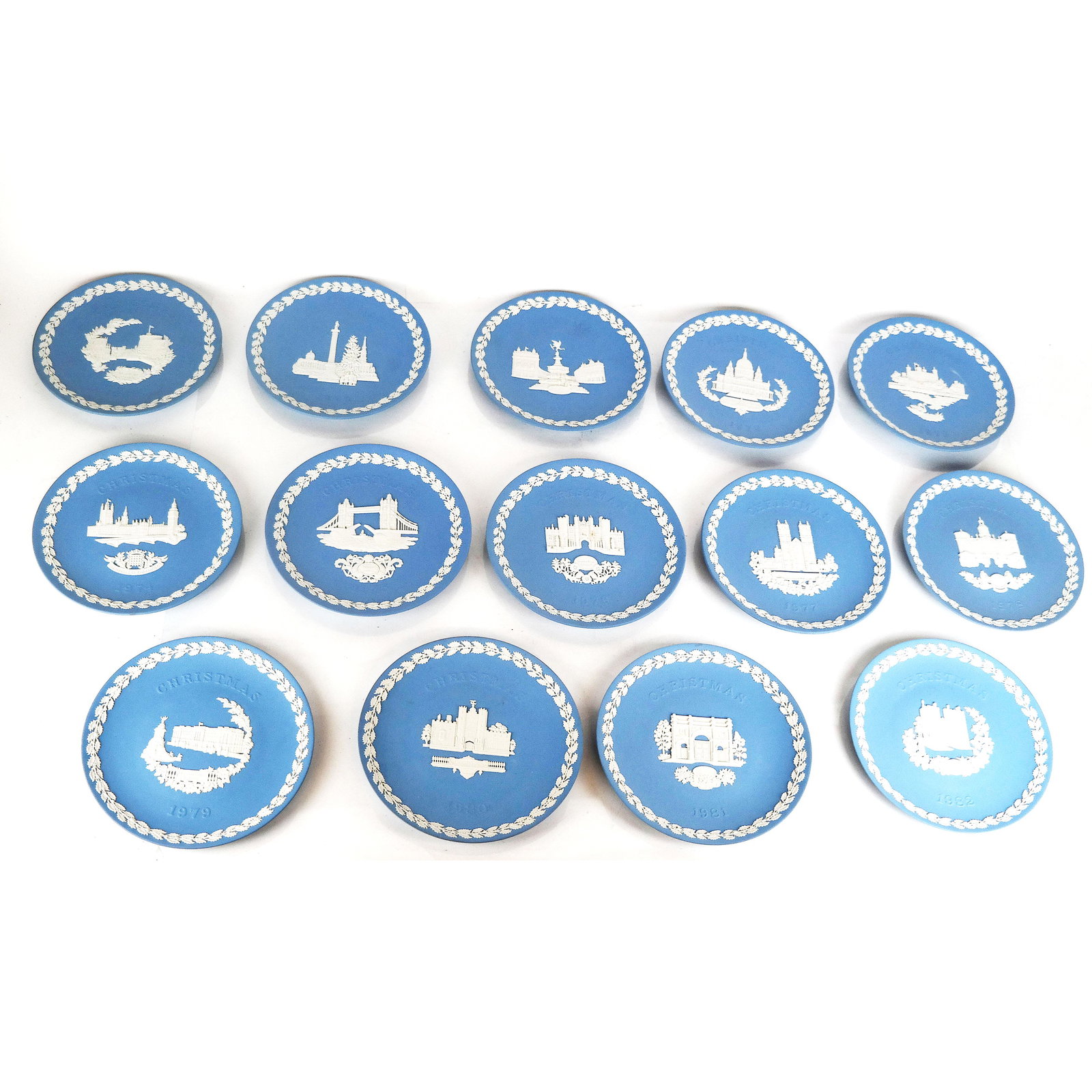 Group of 14 Wedgwood Blue Jasperware Plates: Group of 14 Wedgwood blue jasperware commemorative Christmas plates with English monuments, consecutive years 1969 through 1982. [8 1/8" Diam.]. Some with stains and wear.