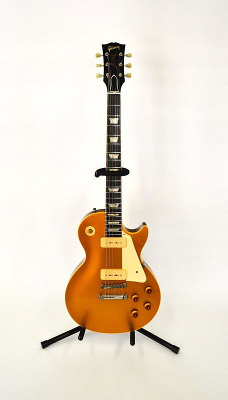 Les Paul Gibson Electric Guitar: Gibson Les Paul gold top serial #65024. Good condition, comes with accessories, Gibson Gold Warranty dated 8/18/95 and a t-shirt signed by Les Paul. Case included.